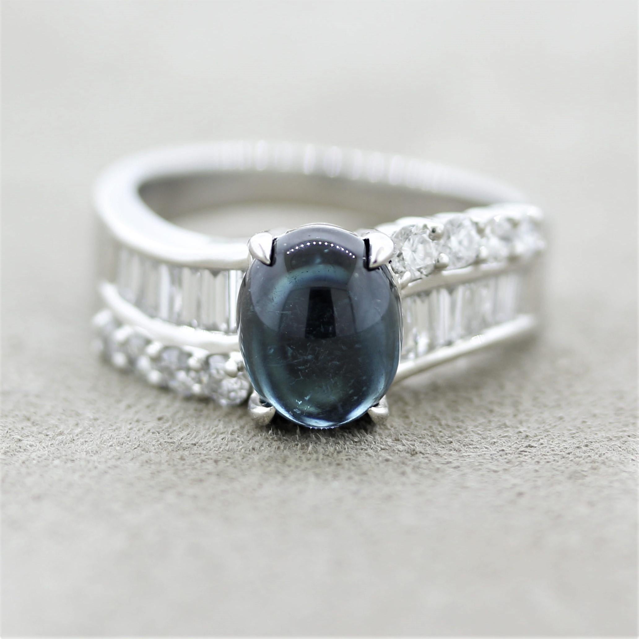 A sleek and sexy platinum ring featuring a gem cabochon tourmaline. It weighs 2.33 carats and has a rich indicolite blue color. It is accented by two rows of diamonds, baguette, and round brilliant, weighing a total of 0.78 carats. Hand-fabricated