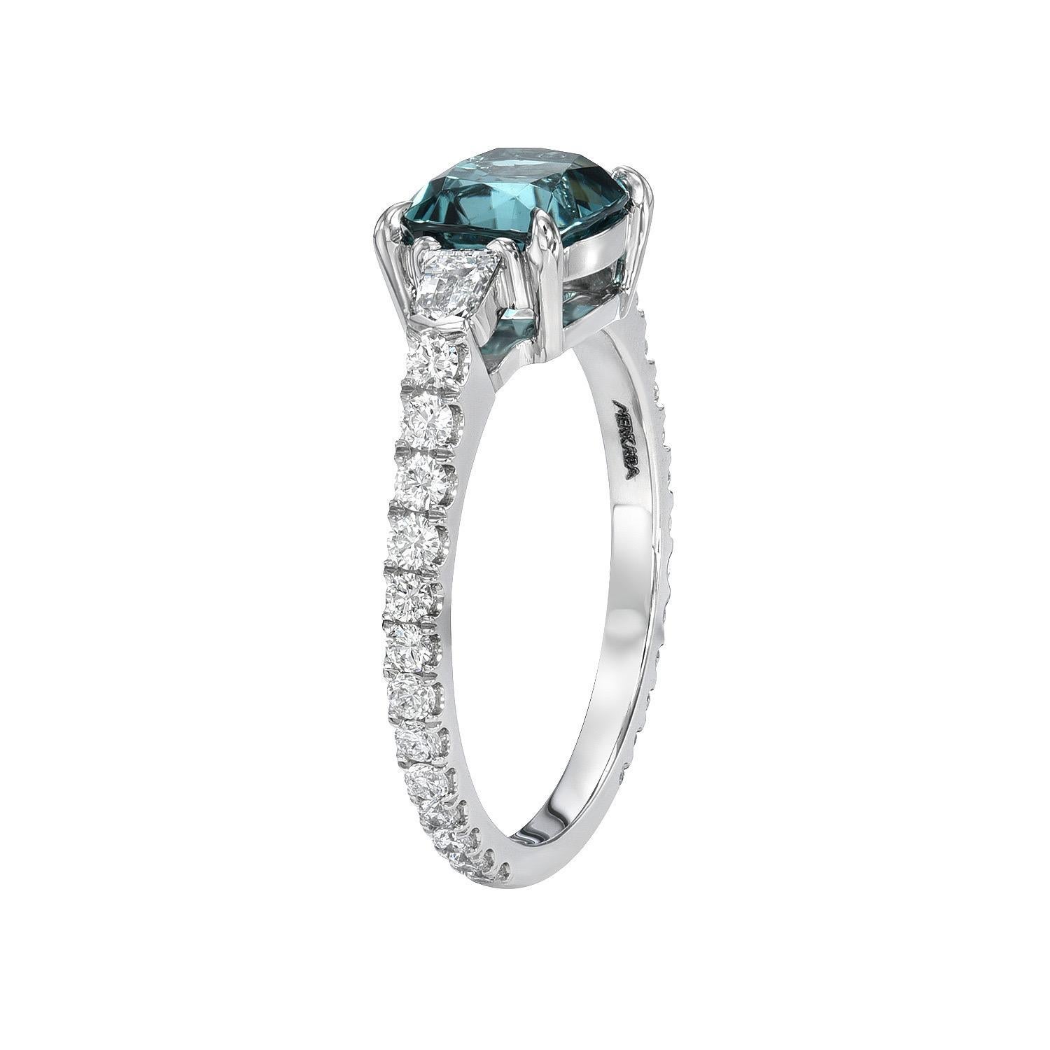 Superb 1.63 carat lagoon-blue Tourmaline cushion platinum ring, flanked by a pair of 0.21 carat D/VS1 diamond bullets, and a total of 0.41 carat round brilliant collection diamonds.
Ring size 6. Resizing is complementary upon request.
Crafted by