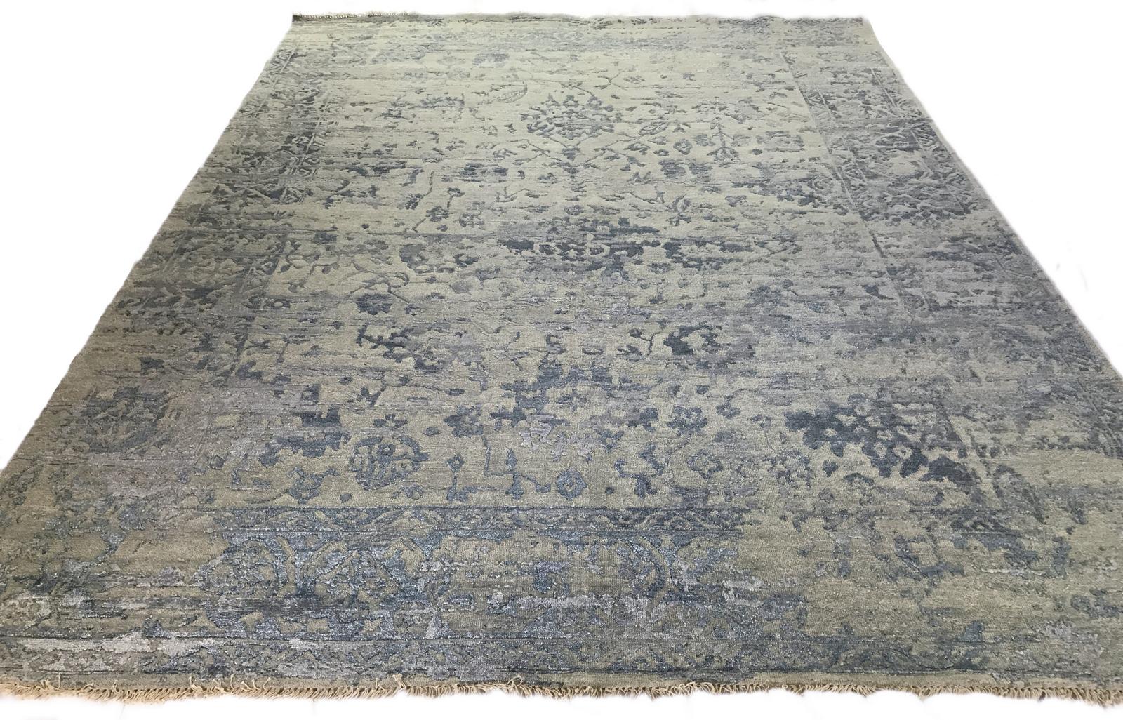 Add another dimension underfoot with this Indian wool/viscose blend area rug featuring a raised traditional design. The high low style in blue against a beige background emphasizes the unique texture that makes this contemporary rug stand out from