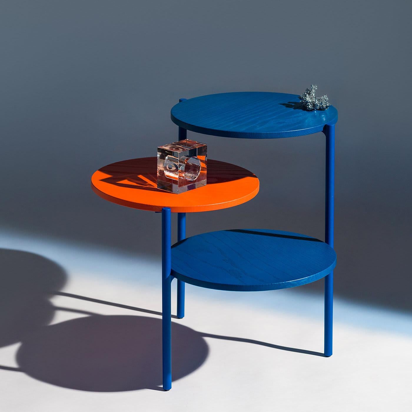 For style and functionality, the Triplo triple table is the perfect complimenting accessory to your favorite living space. With colored table tops crafted from solid wood and a support frame in blue metal, this accessory offers a compact way to