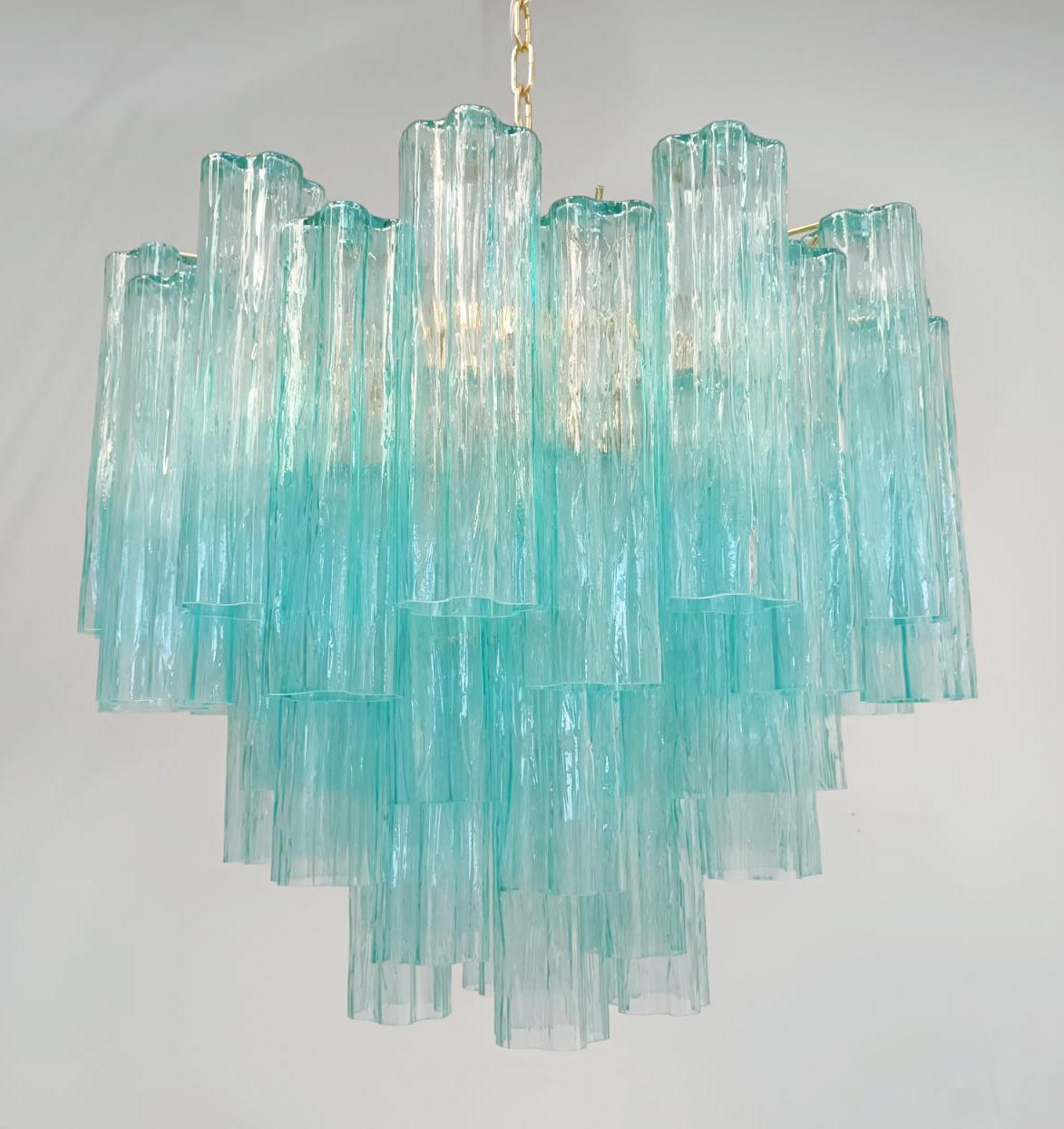 Italian chandelier with vintage 1960s Venini blue Murano tronchi glasses, mounted on newly made gold finish metal frame / Made in Italy
7 lights / E26 or E27 type / max 60W each 
Measures: diameter 23.5 inches, height 20.5 inches plus chain and