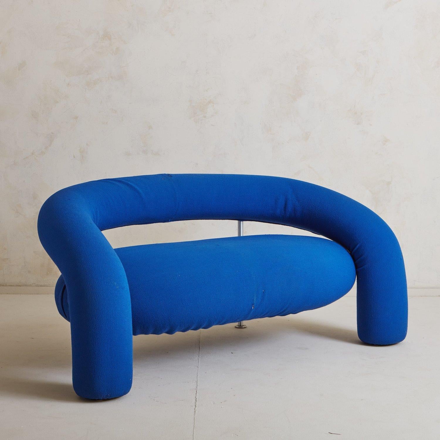 A two-seater ‘Tube’ sofa designed by Anna and Carlo Bartoli for Italian manufacturer Rossi di Albizzate in the early 1990s. This iconic sofa has a metal frame padded with polyurethane foam and two tubular aluminum supports. It has a beautiful,