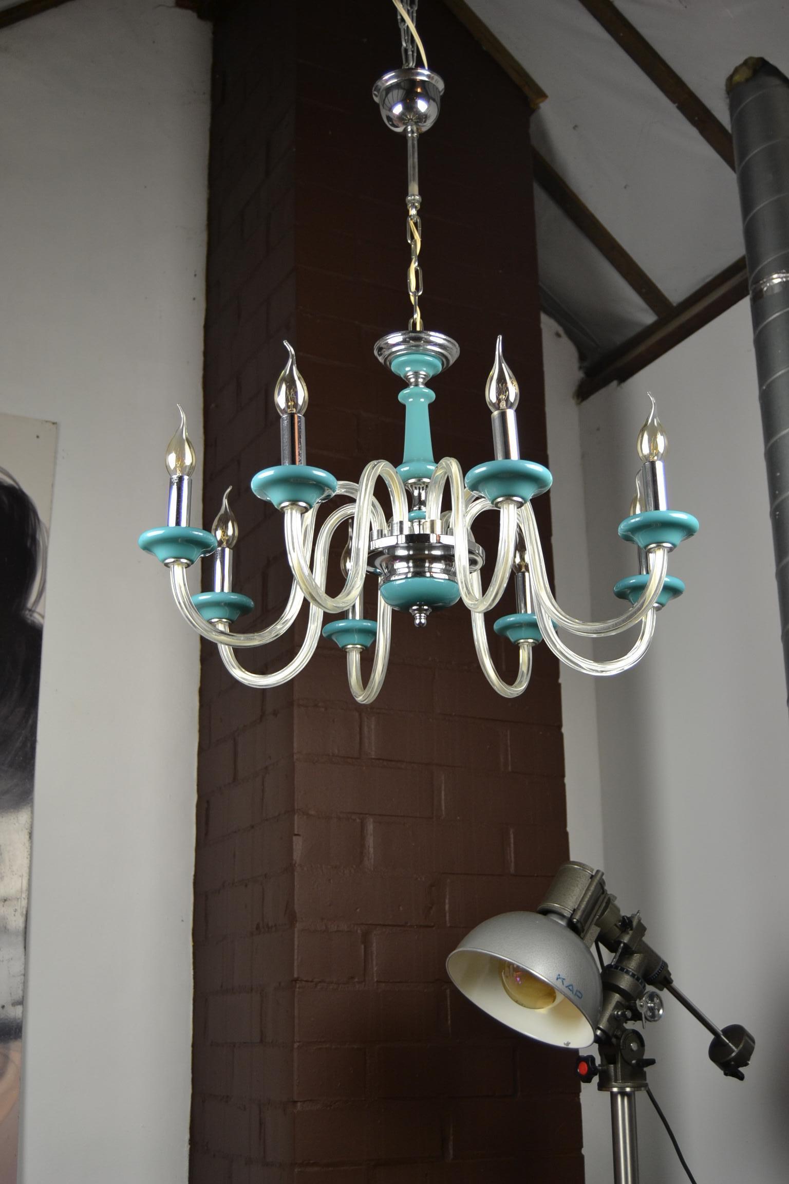 Mid-20th Century Blue Murano Glass Chandelier with chromed details.
This vintage Italian 8-armed chandelier has the beautiful color turquoise blue. 
 
This ceiling light is perfect for the summer, summer house, summer bar, summer club, beach bar,