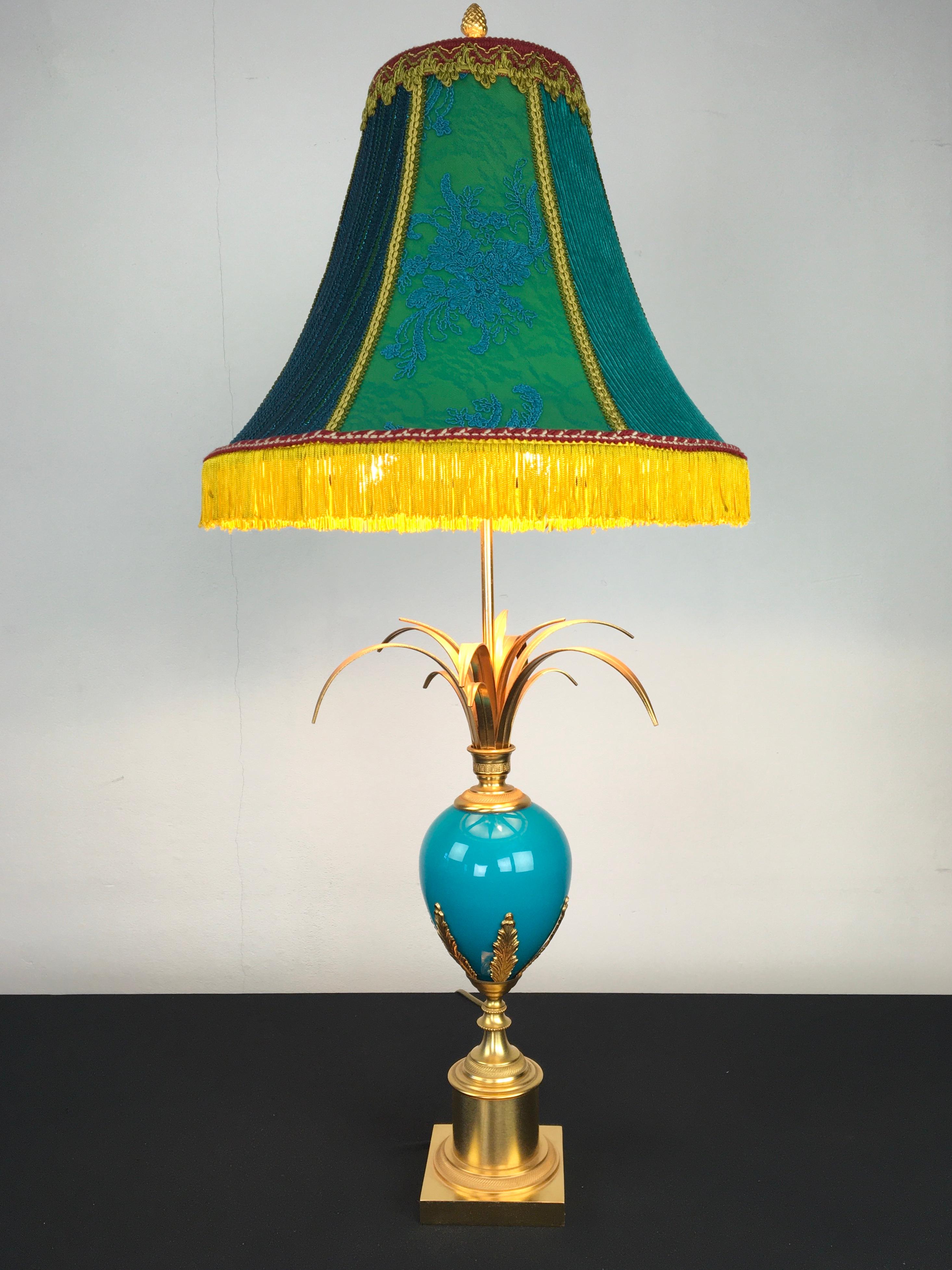 Great looking blue turquoise ostrich egg table lamp by S.A. Boulanger. 
A table lamp with a blue opaline ostrich egg and palm leaves on top. 
The base is made of brass with moulded brass leaves on the opal egg and with a pine cone finish on top.
