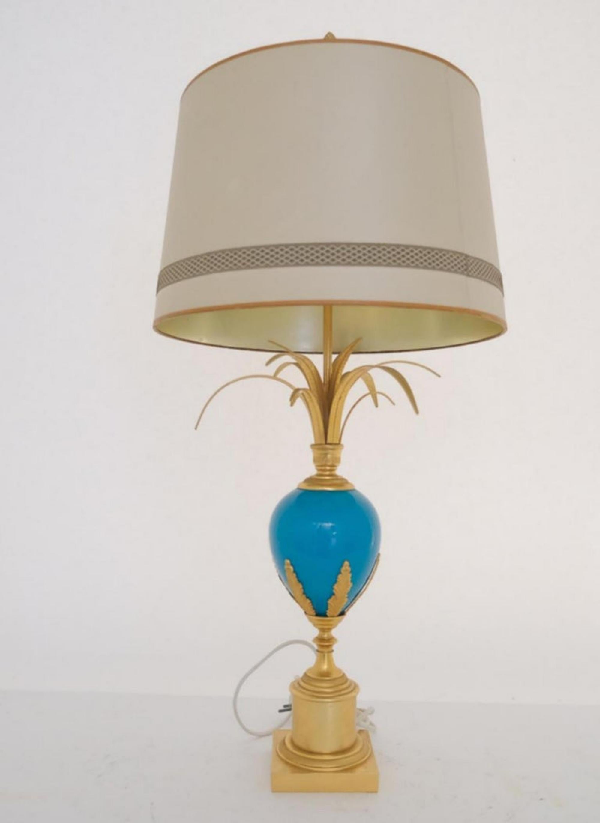 Blue Turquoise Opaline Ostrich Egg Table Lamp, S.A. Boulanger

Blue turquoise ostrich egg table lamp by S.A. Boulanger.  A stylish table lamp with a blue opaline ostrich egg and palm leaves on top.  The base is made of brass with moulded brass