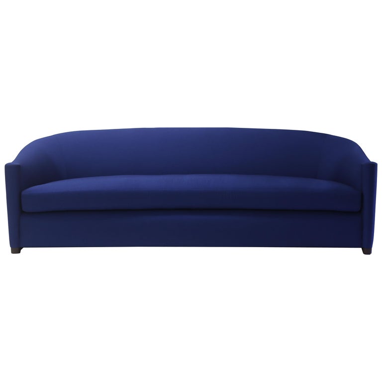 Blue Upholstered Curved Sofa with Wood Base and Loose Seat Cushion on