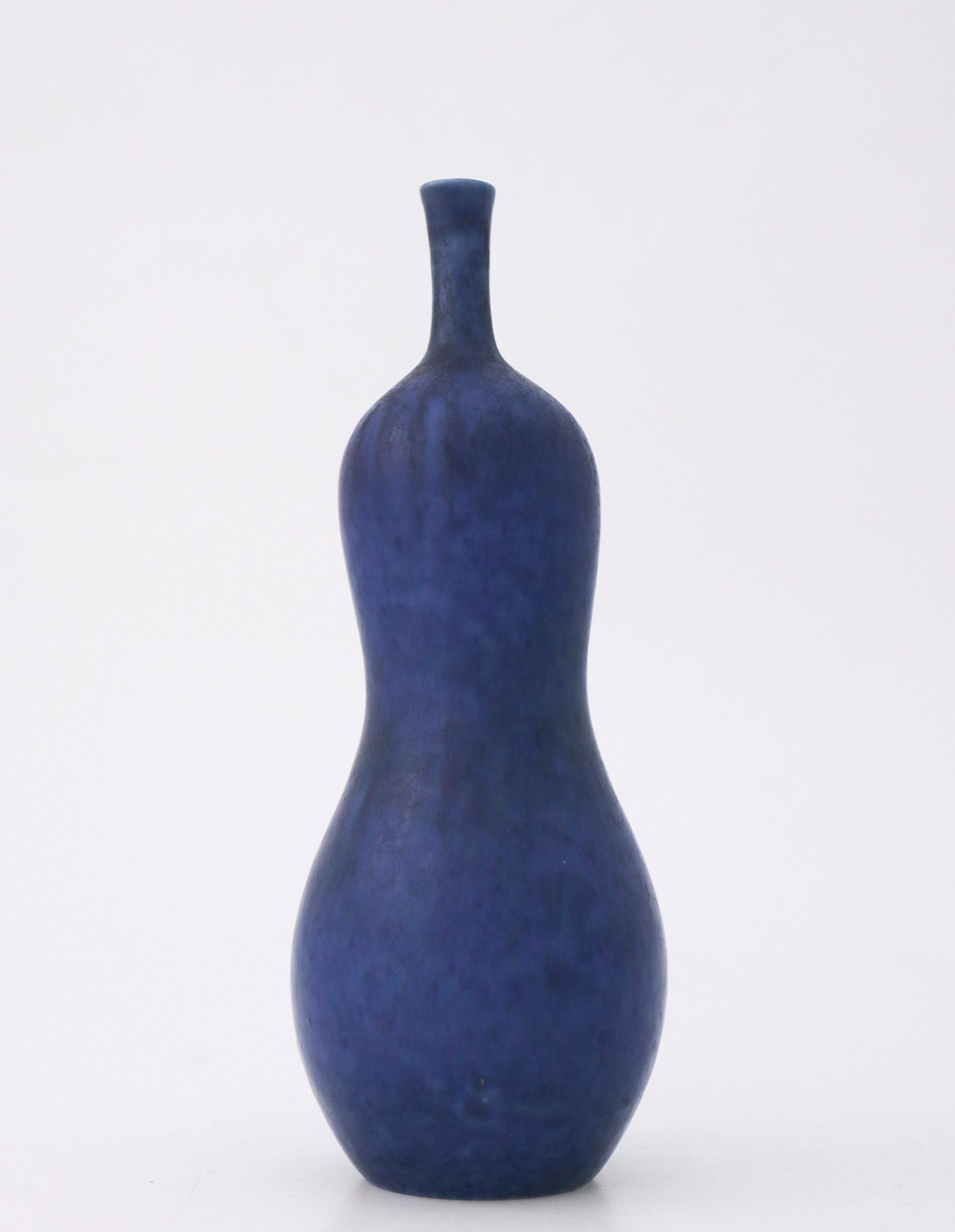 A lovely blue probably unique vase designed by Carl-Harry Stålhane at Rörstrand in the late 1940s the vase is 19.5 cm high. It has a minor white mark in the glaze except from that it is in excellent condition. 

Carl-Harry Stålhane is one of the top