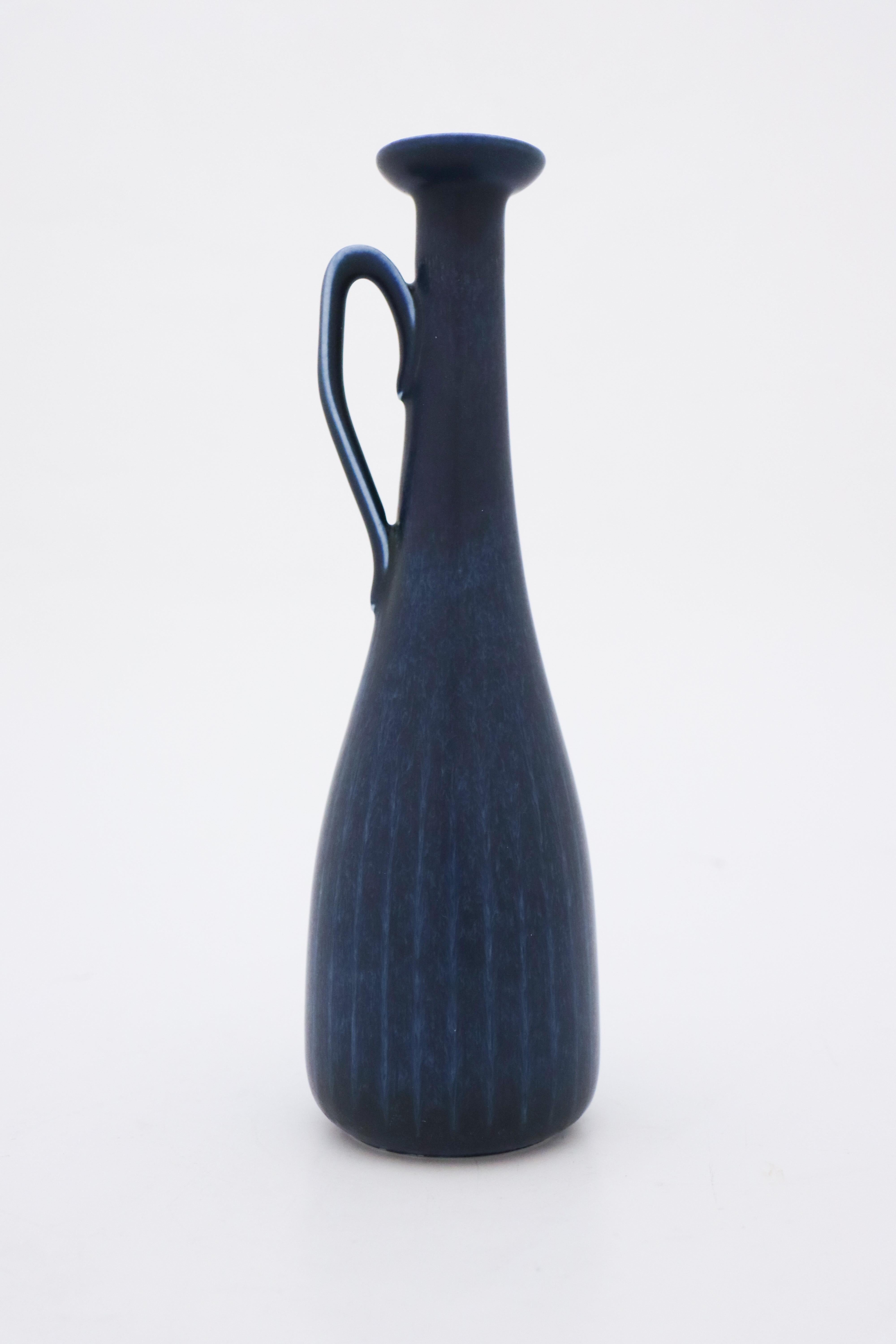 A brown vase designed by Gunnar Nylund at Rörstrand, it´s 24.5 cm (9,8) high. It´s in mint condition and marked as 1:st quality. 

Gunnar Nylund was born in Paris 1904 with parents who worked as sculptors and designer so he really soon started hos