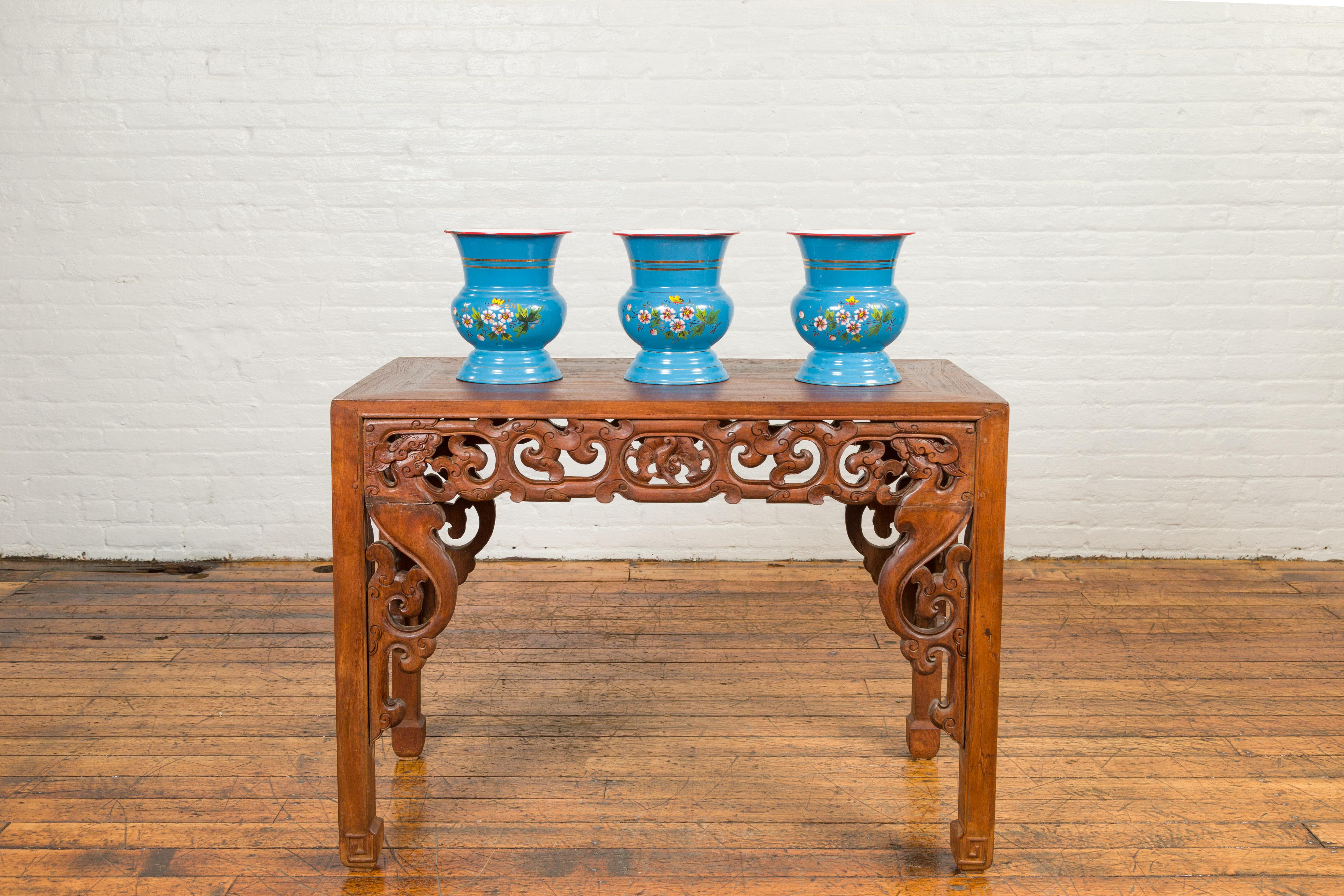 Three blue metal vases from the 20th century, with painted floral decor and read trim, priced and sold each. Crafted with metal from Czechoslovakia, each of these vases (priced $550 each) features a flaring neck topped with a red trim. The body,