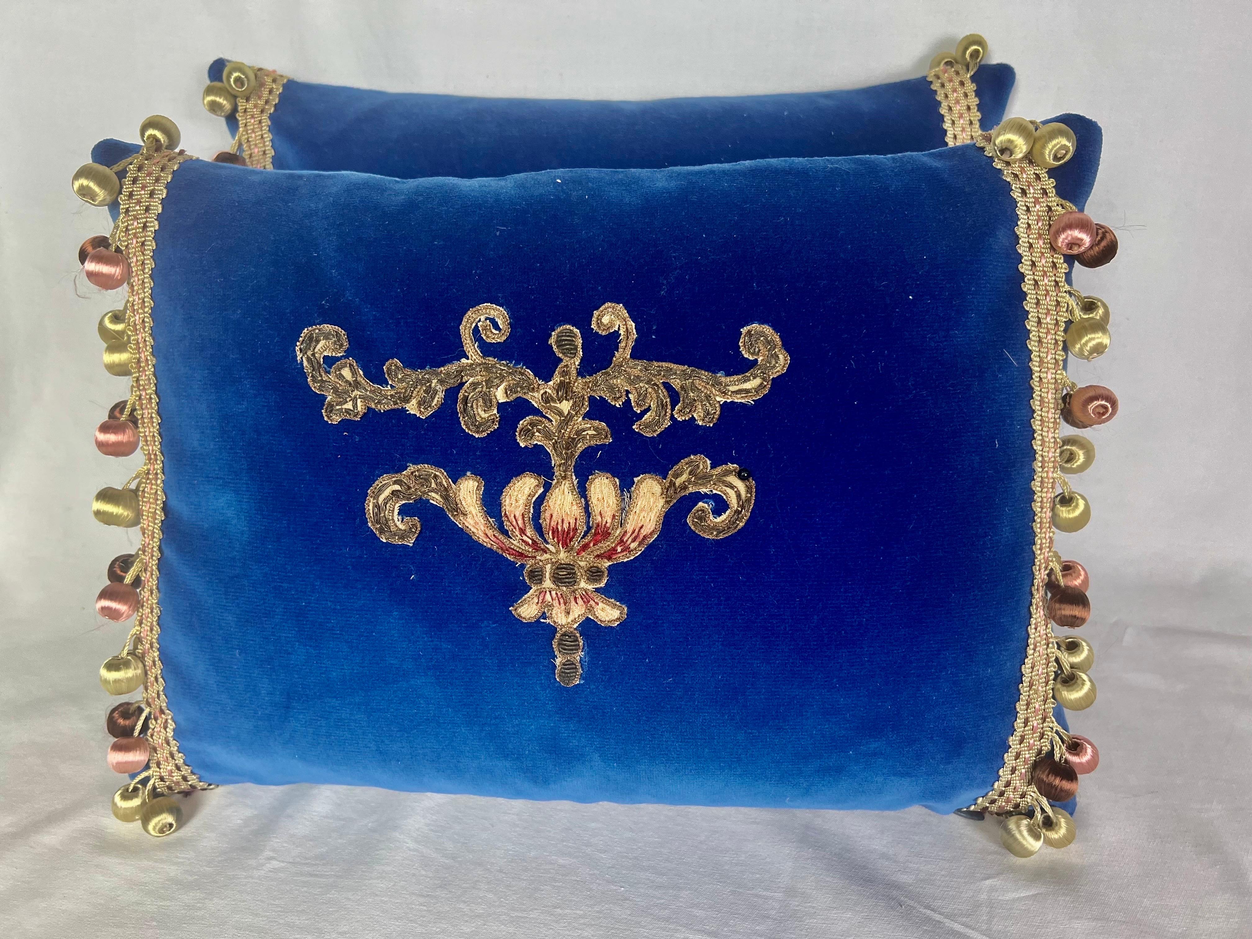 Pair of custom newly constructed blue silk velvet pillows with 19th century French metallic & chenille applques. Down inserts, zipper closures.