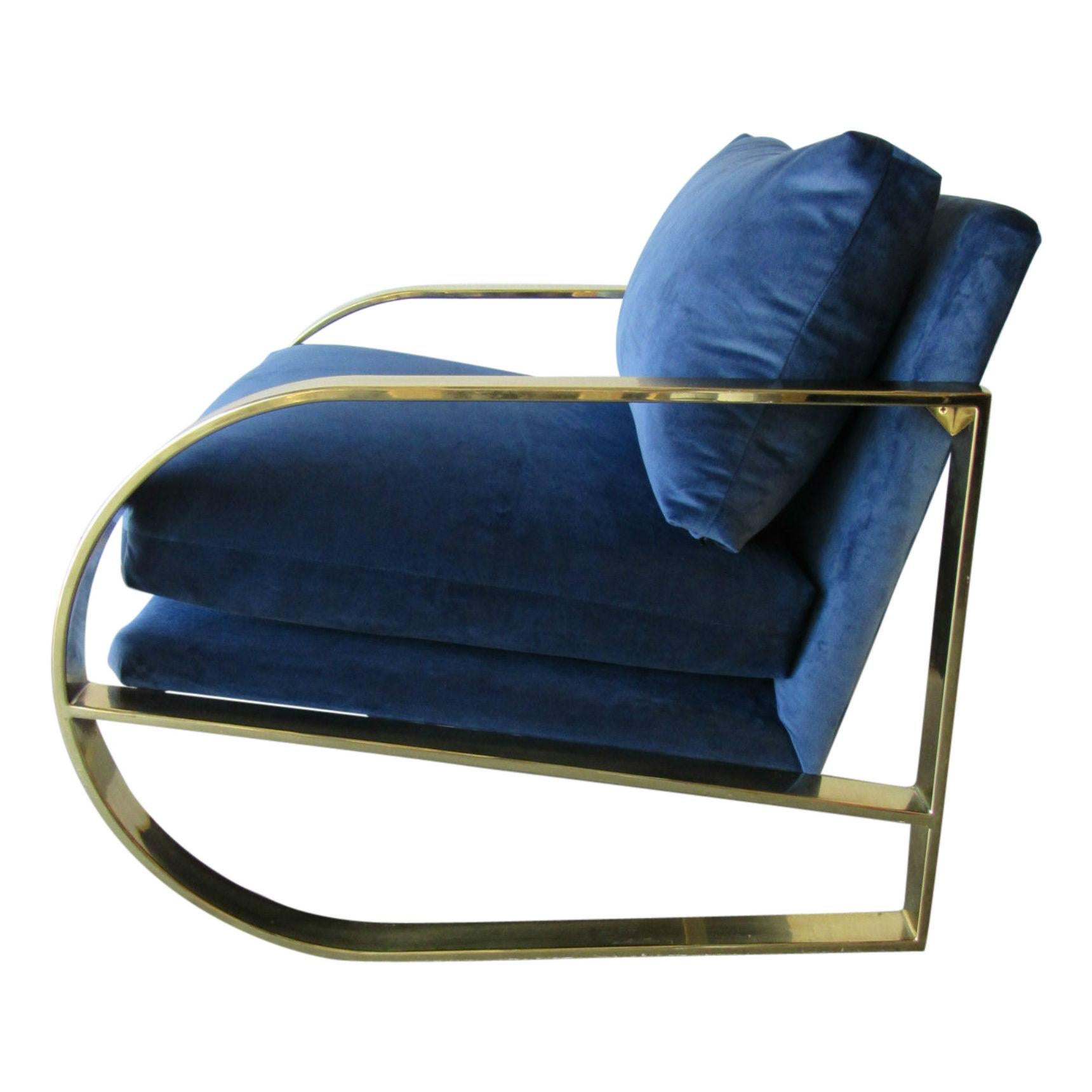 This chair strikes the perfect balance between geometric hard edges and soft upholstered luxury. Designed by renowned furniture designer John Mascheroni for Swaim in the 1960s this lounge chair has a lacquered brass frame and new blue velvet