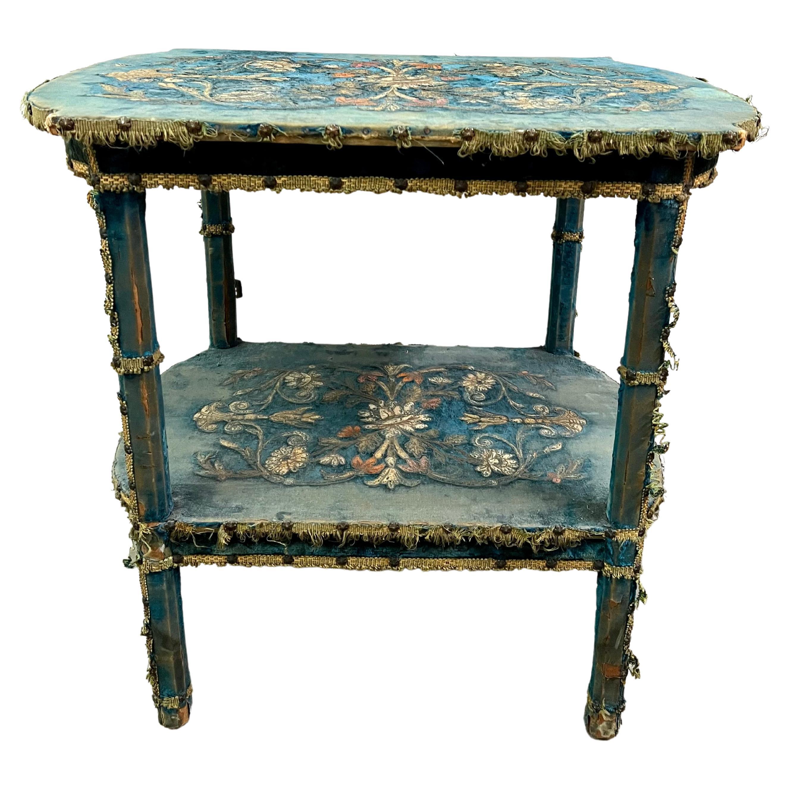 Wooden table line in blue velvet upholstery which has worn away to a beautiful patina. Featuring a floral pattern in an early Swedish Scandinavian style. The piece looks to be Victorian, but also works well in Arts and crafts environments.