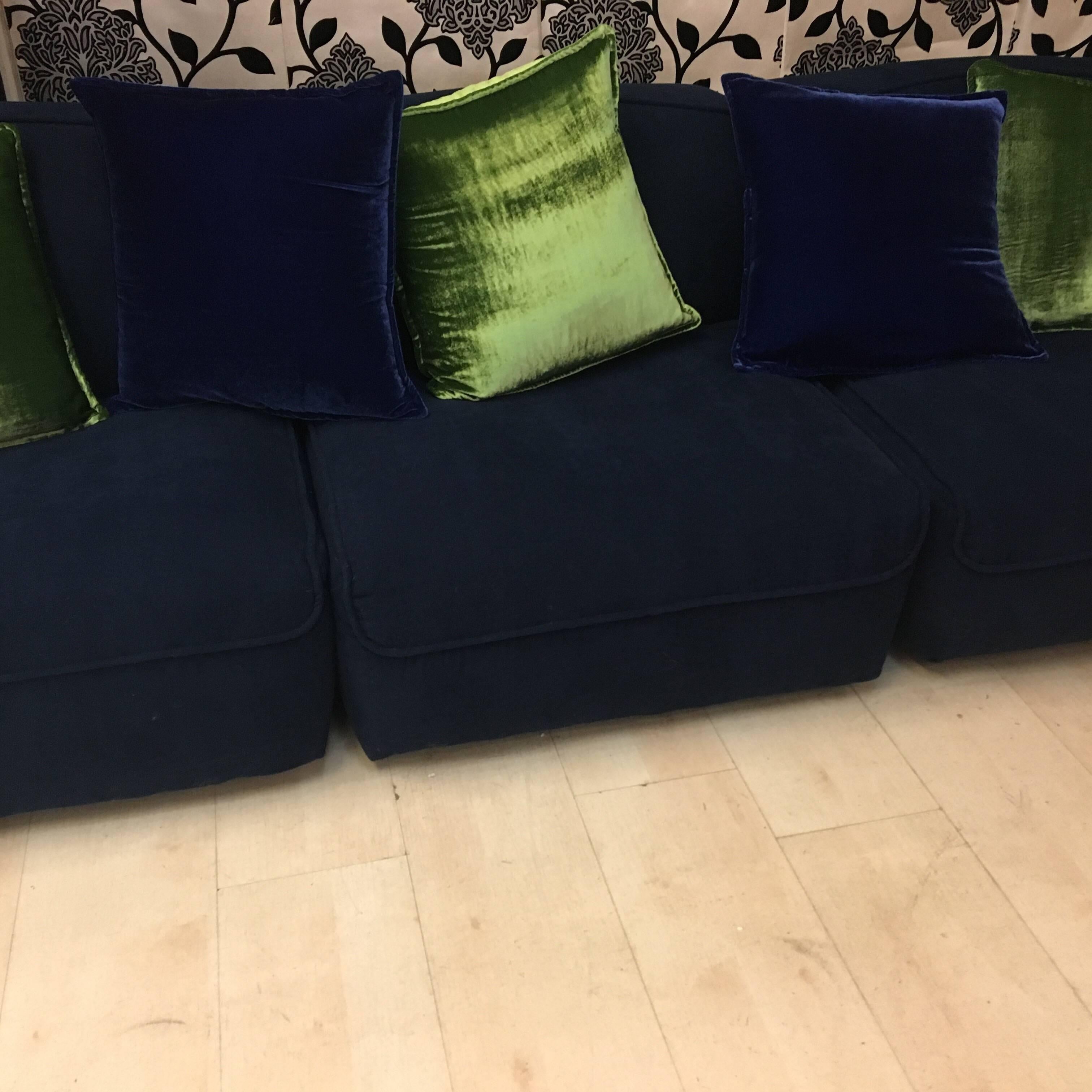 Blue velvet sectional Italian sofa newly upholstered, three chair pieces with acid green and blue velvet pillows.