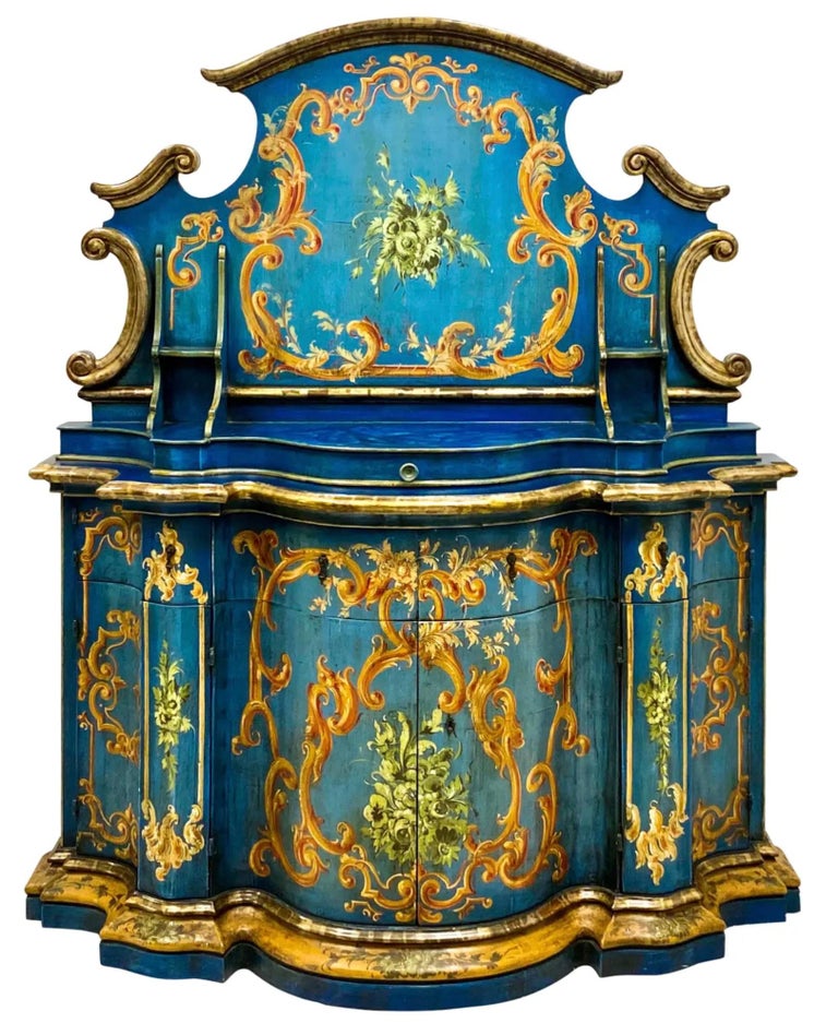 Wow! There are no words for how beautiful this Venetian cabinet is. The exterior is blue with silver gilt trim. The floral color explosion is predominantly oranges and greens. The interior is yellow silk. It does have the original jey, and the top