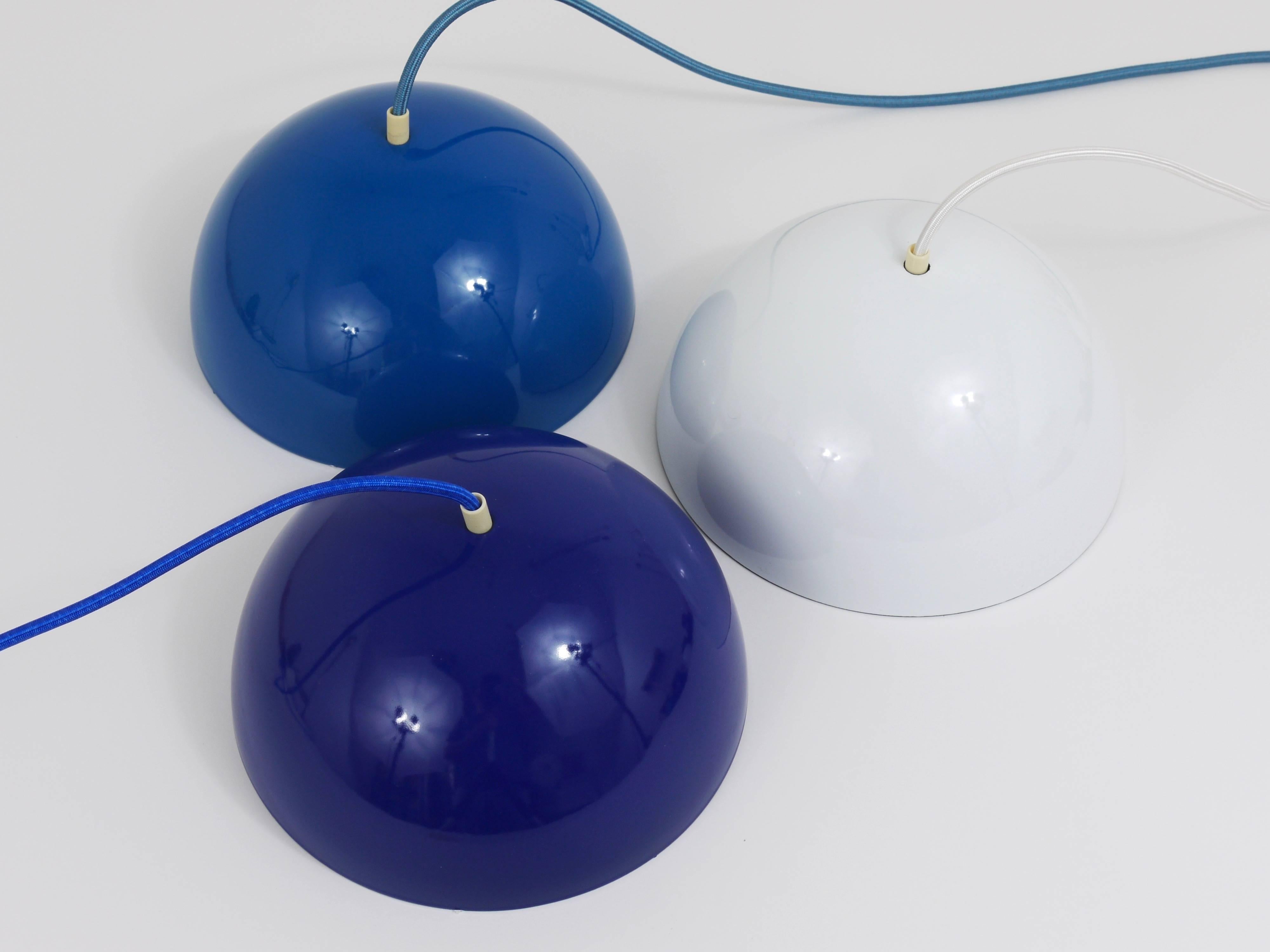 An iconic cobalt-blue flowerpot pendant light, designed in 1969 by Verner Panton for Louis Pulsen, Denmark. A simple but beautiful ceiling light, consisting of two enameled hemispherical lampshades facing each other. The lower lampshade has a red