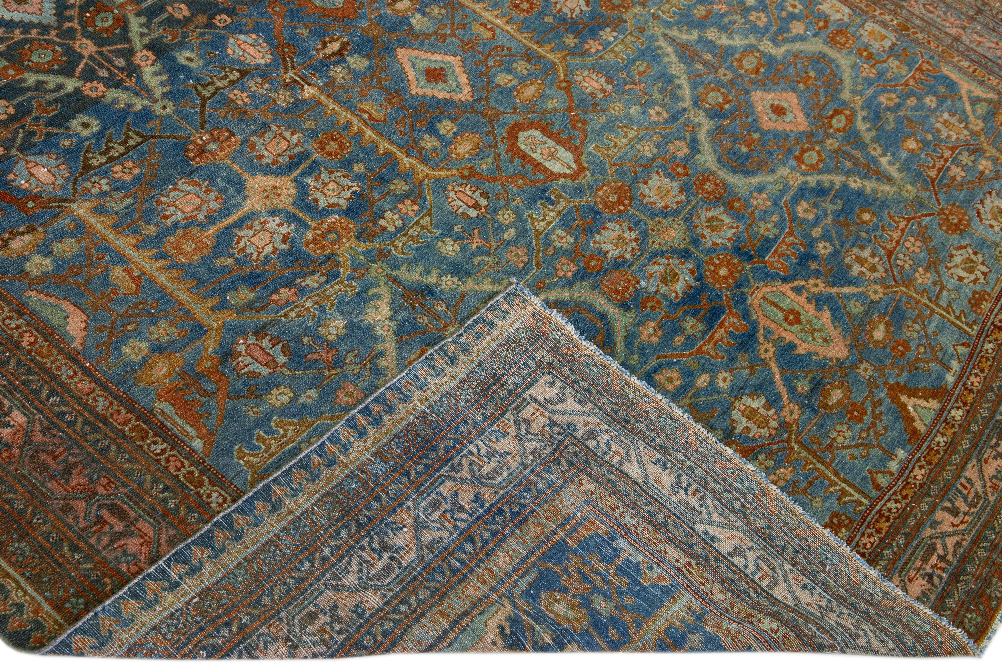 Beautiful vintage Hamadan hand-knotted wool runner with a blue field. This Persian rug has a peach frame and accents of rust in an all-over gorgeous geometric floral pattern design.

This rug measures: 7' 2