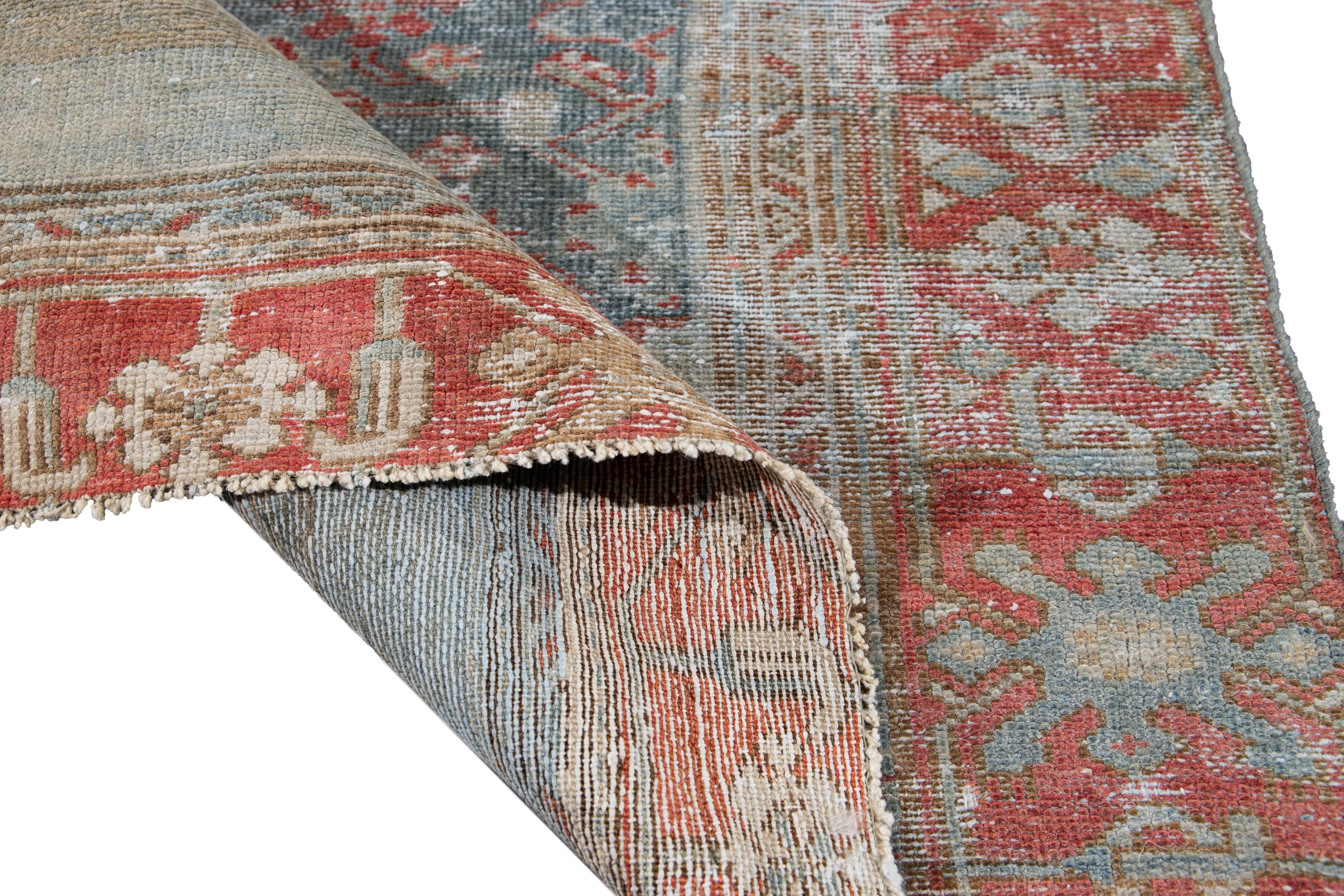 Beautiful vintage Persian Malayer hand knotted wool runner with a blue field. This Malayer runner has accents of red and brown in an all-over distressed geometric Botanical design.

This rug measures: 3'1