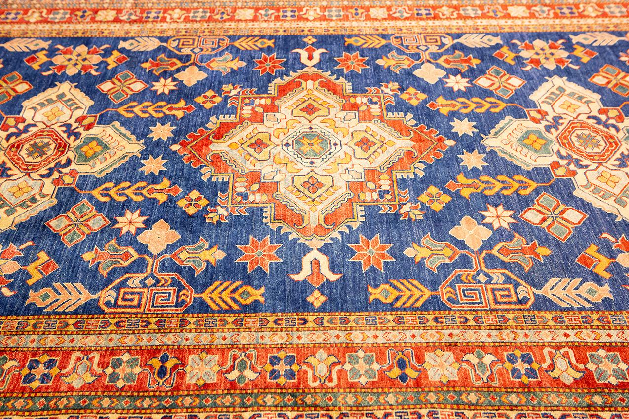 Introducing the Blue Vintage Uzbek Royal Rug with Geometric Design! This beautiful rug is perfect for adding a touch of elegance to any home. The bright and shiny colors are sure to make a statement in any room. This Blue Vintage Uzbek Royal Rug is