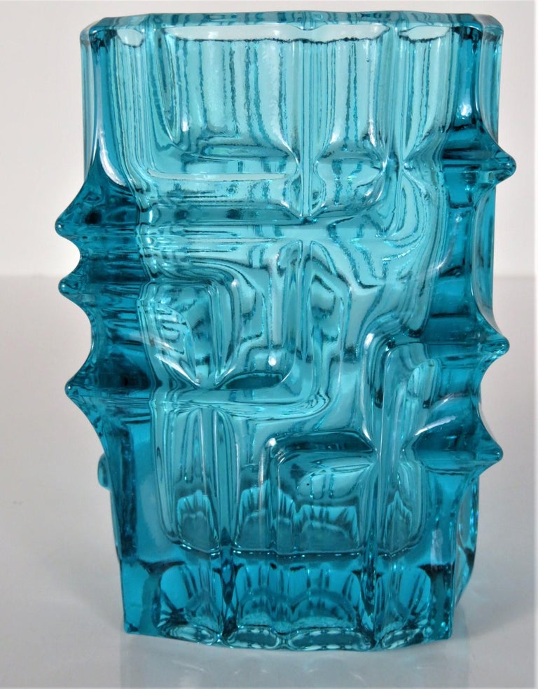 Vladislav Urban, born 1937 Pilsen, Czechoslovakia, is a glass and jewelry designer. Urban, among others, was instrumental in the evolution of Czech pressed lead glass production. This midcentury modern lovely heavy aquamarine pressed glass vase
