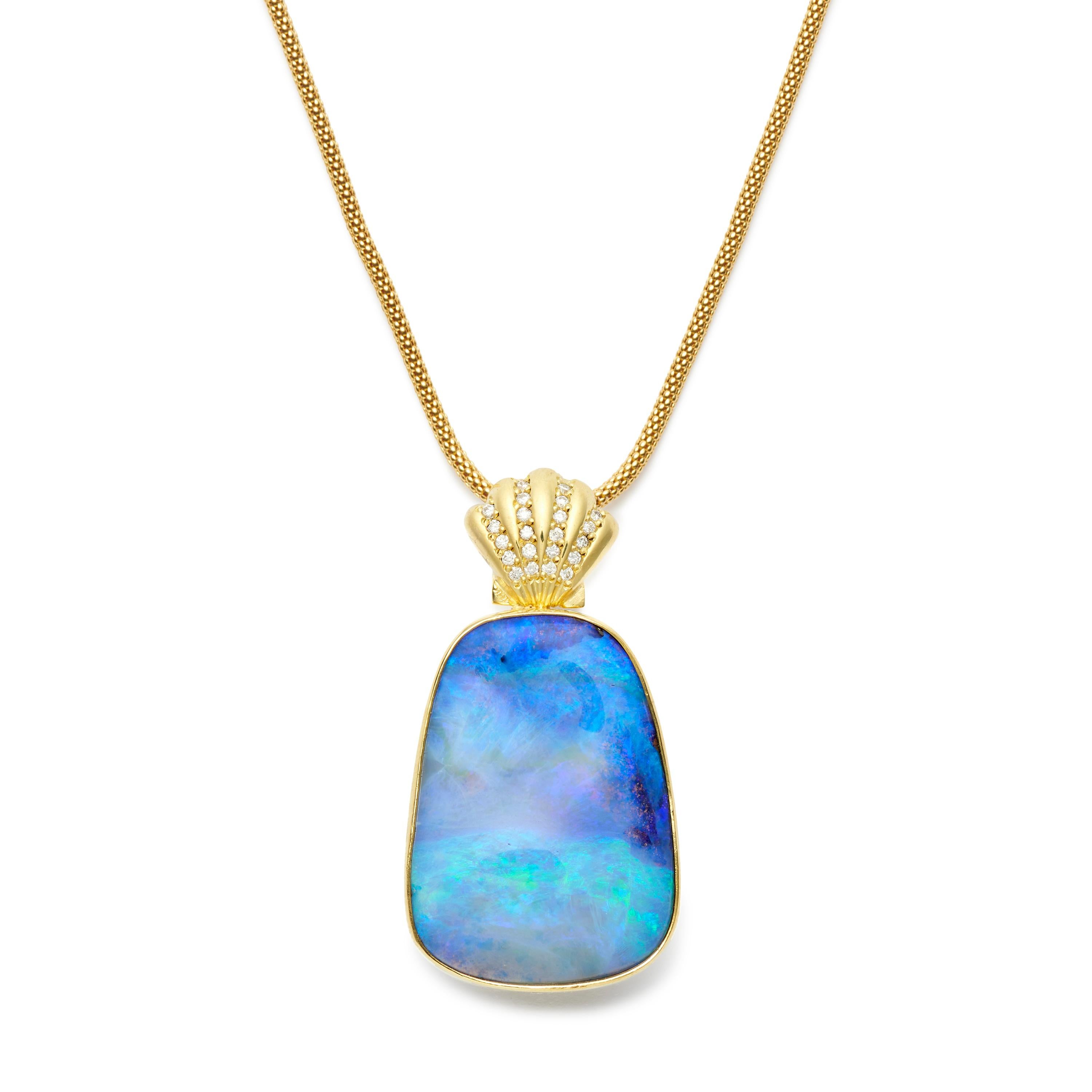 This beguiling Boulder Opal Pendant, with its intense blue hues, mesmerizes, like the colors of the ocean, the moment you look at it. A large and lovely piece that hangs from an 18 karat Gold and Diamond Scallop Shell bale and can be displayed from