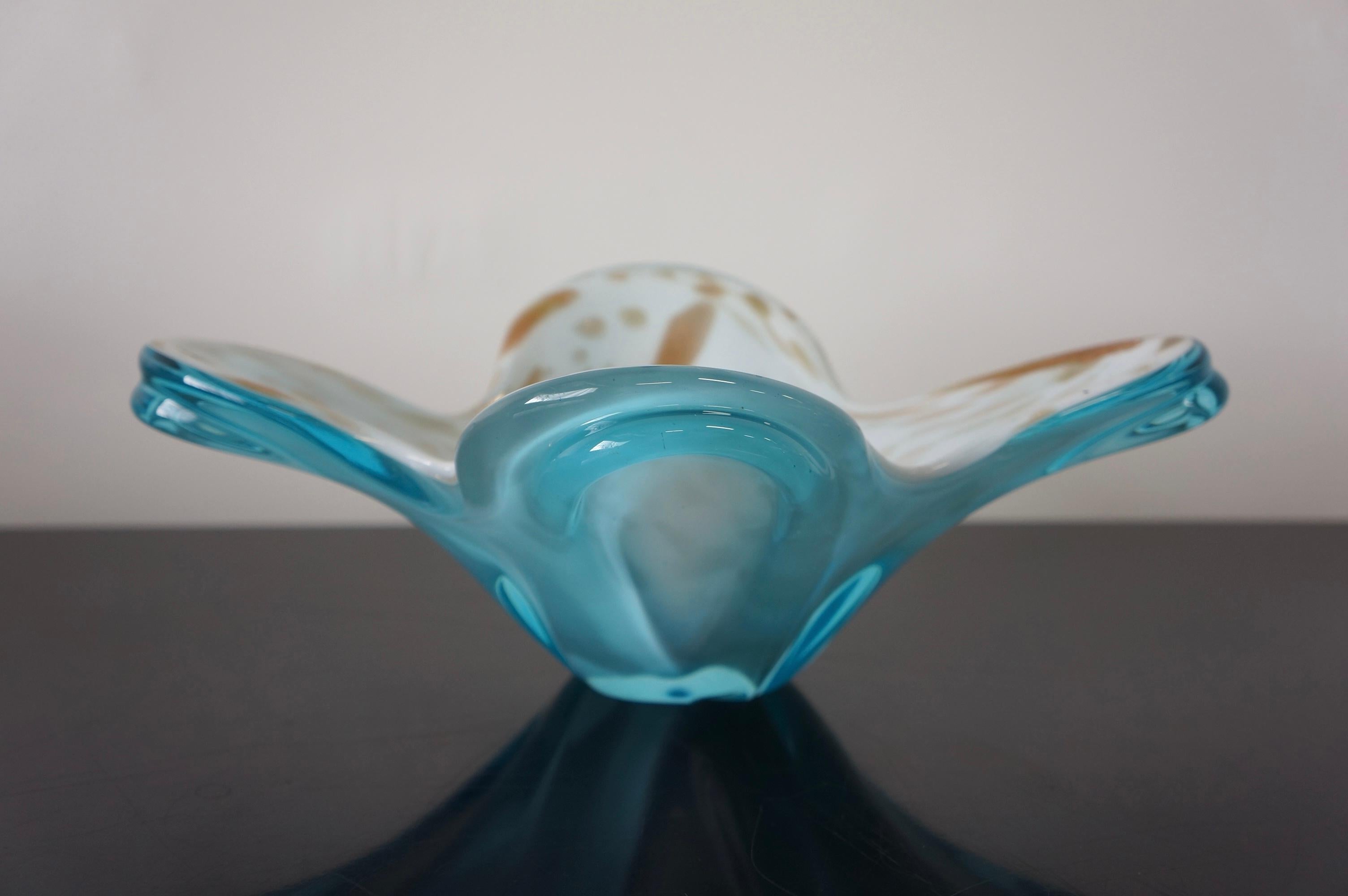 Stunning Murano Art glass decorative bowl in Blue, white, and gold speckle. It is three toned and made with layered glass. Featuring aqua blue glass at the bottom, white glass on top, and gold speckled spots. The vibrant tones make it such an eye