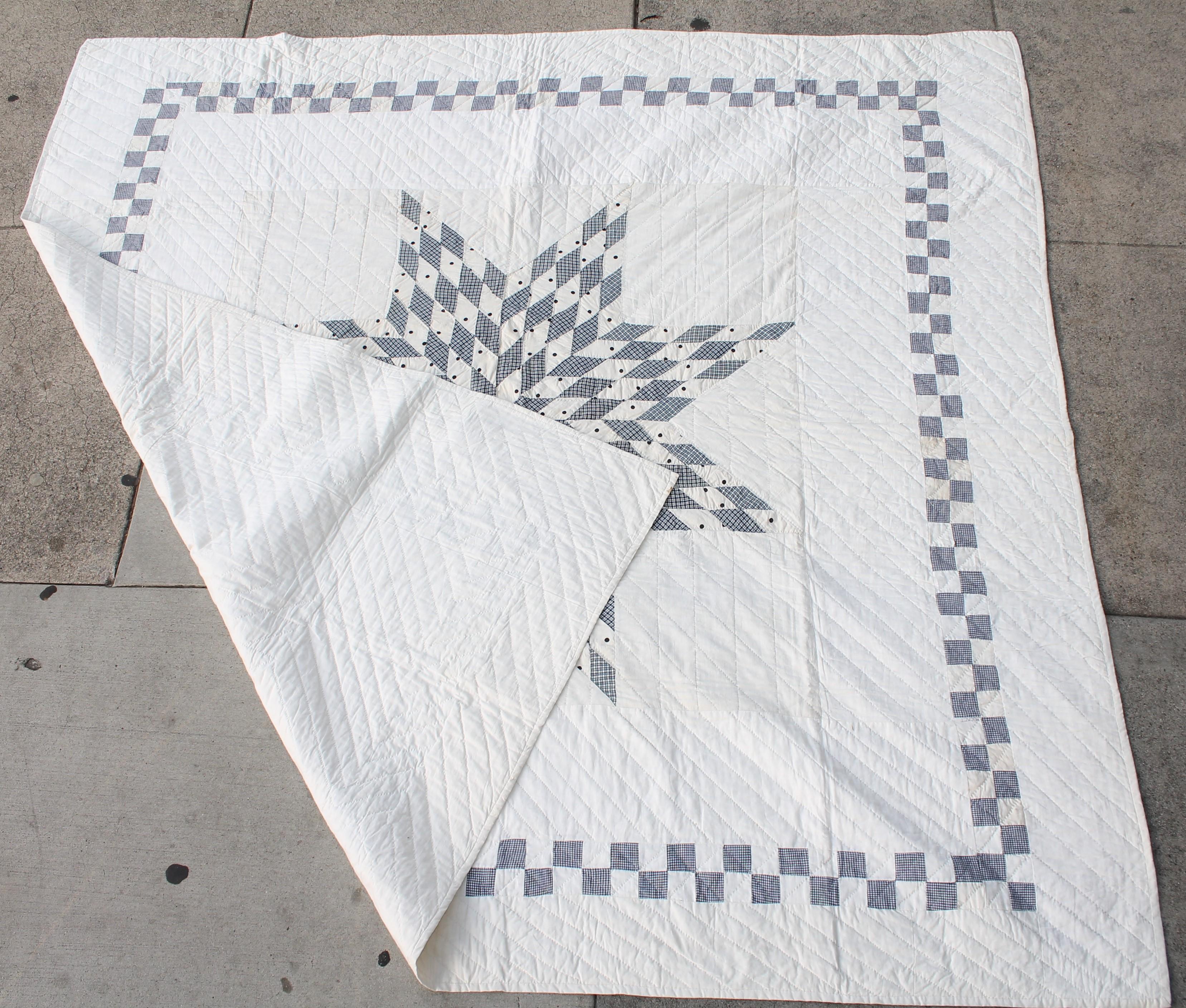 Blue and white eight point star from Pennsylvania. Made from blue and white check fabric. Fine piecework and nice quilting.