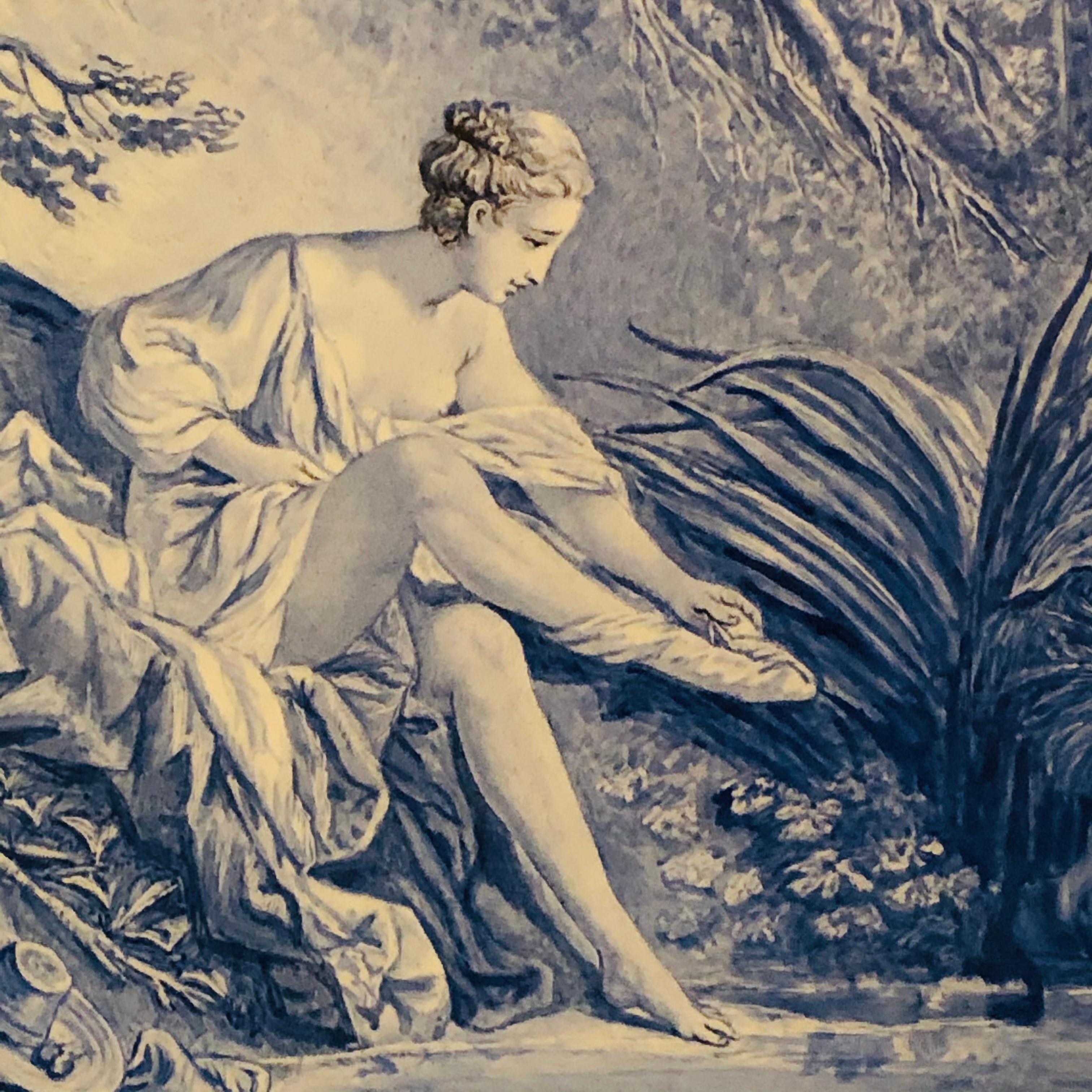 This is an enchanting French blue and white ceramic plaque Artist-signed M. De Pavee of a scene in the forest of a beautiful young lady dressing with a young boy watching her hiding in the high grass. It is painted in a beautiful shade of blue, and