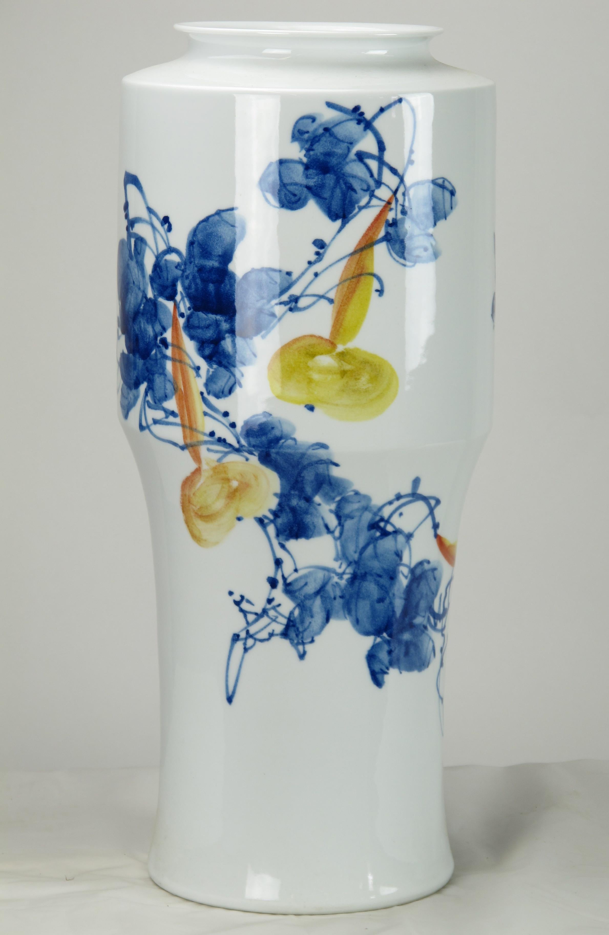 This modern blue & white porcelain vase was designed and made by Mr. Zhou, an artisan from Jingdezhen, an ancient city in the north east of Jiangxi province and well known for its porcelain industry. The shape and painting of each vase created by