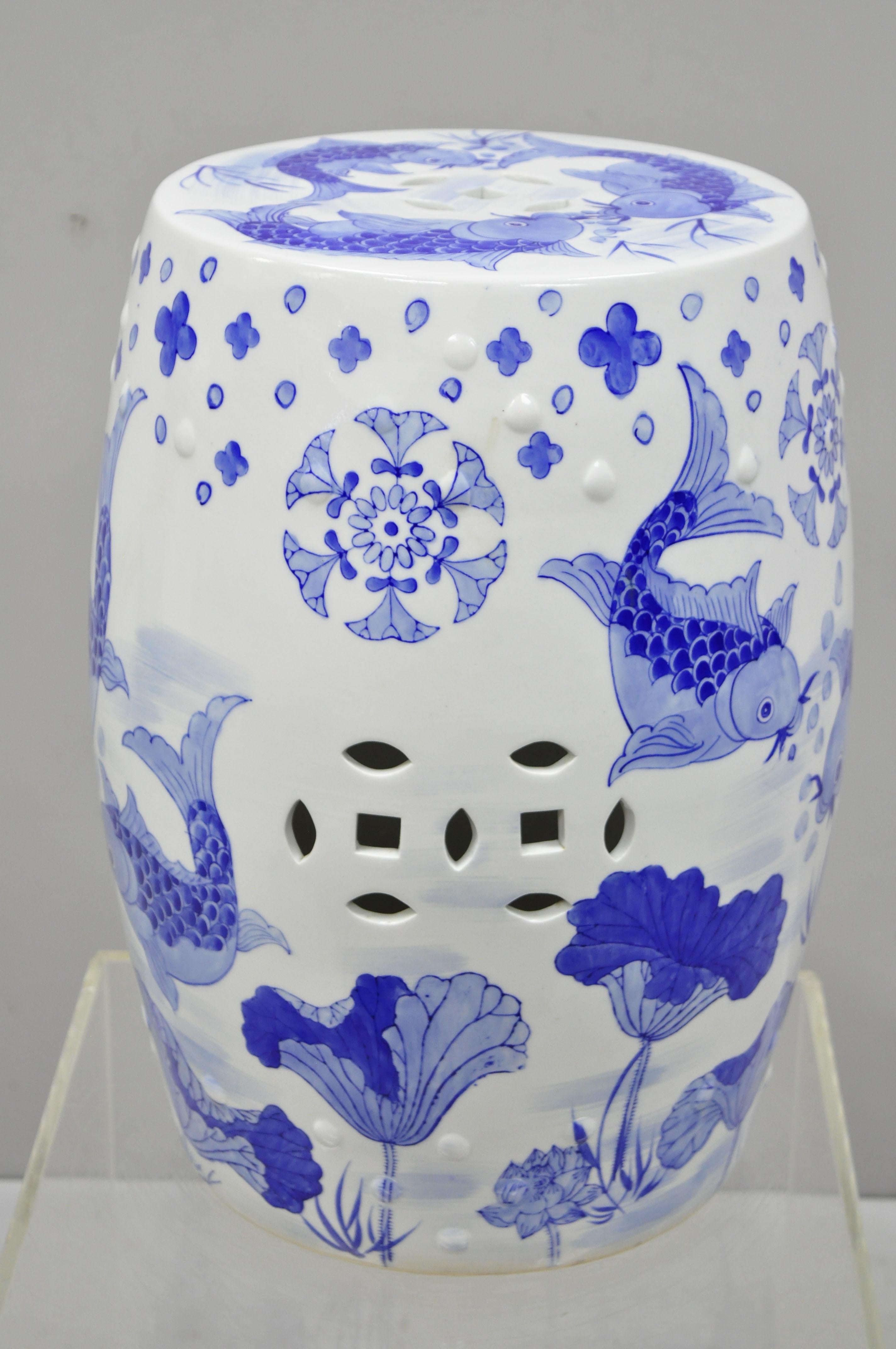 Blue and white porcelain Chinese garden seat with koi fish. Item features believed to be early to mid-20th century. Measurements: 18