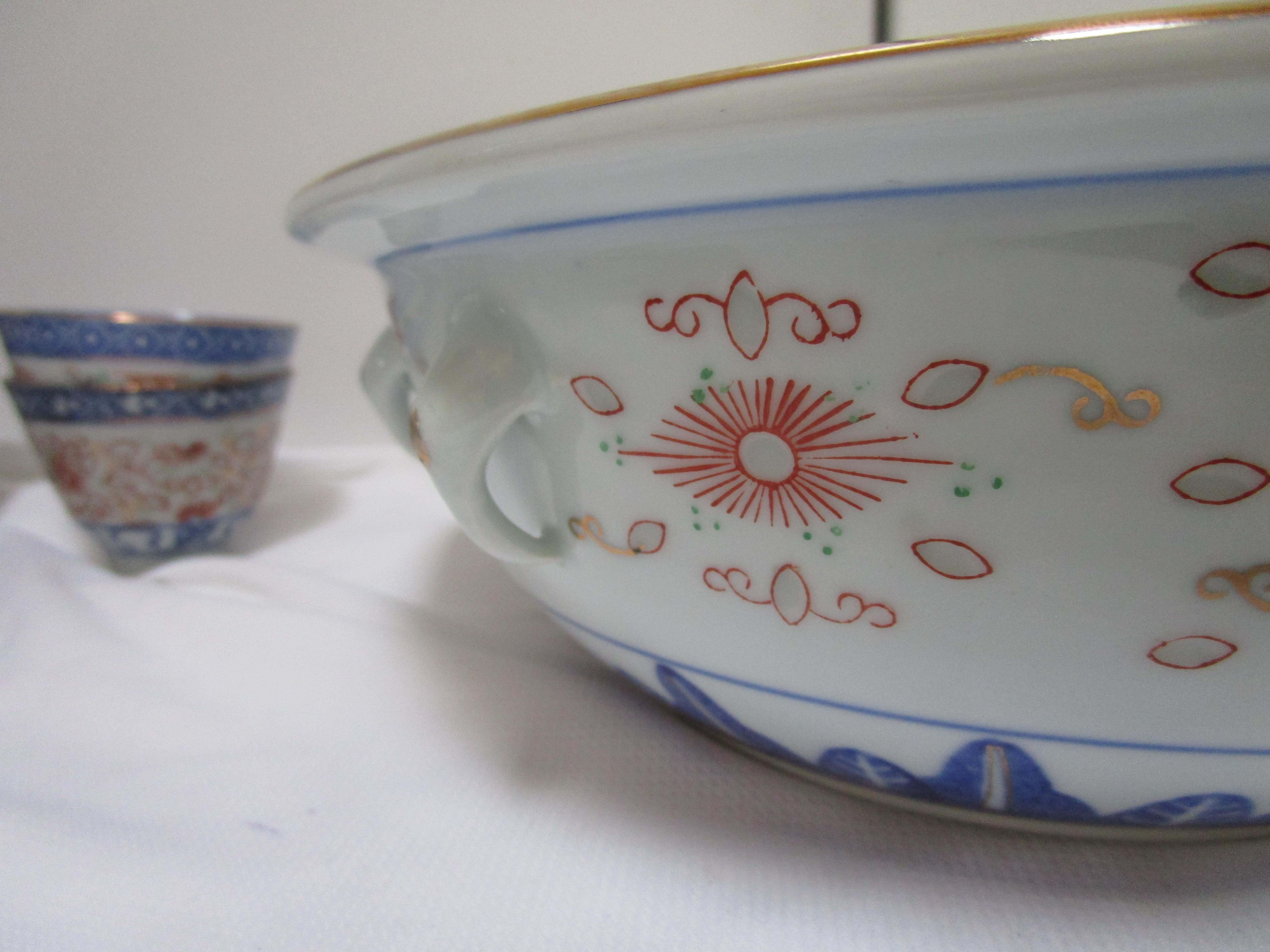 This is a special collection of blue and white rice grain porcelain serving bowls and Chinese style teacups. They are beautiful in red, blue and white translucent rice grain pattern with the lotus flower motif. The items are assembled and the