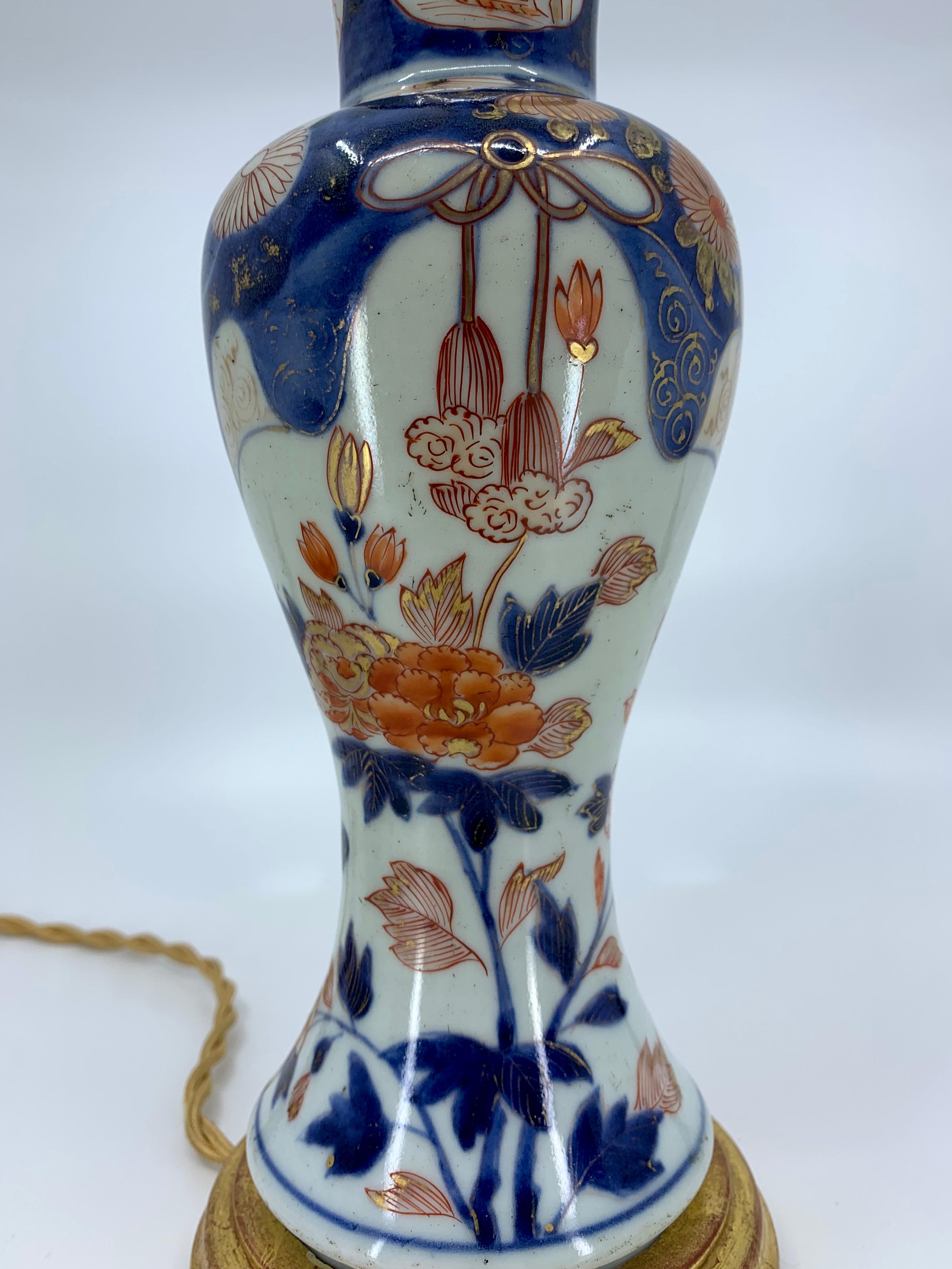 Hand-Painted Blue, White, Red and Gilt Porcelain Lamp on Giltwood Base For Sale