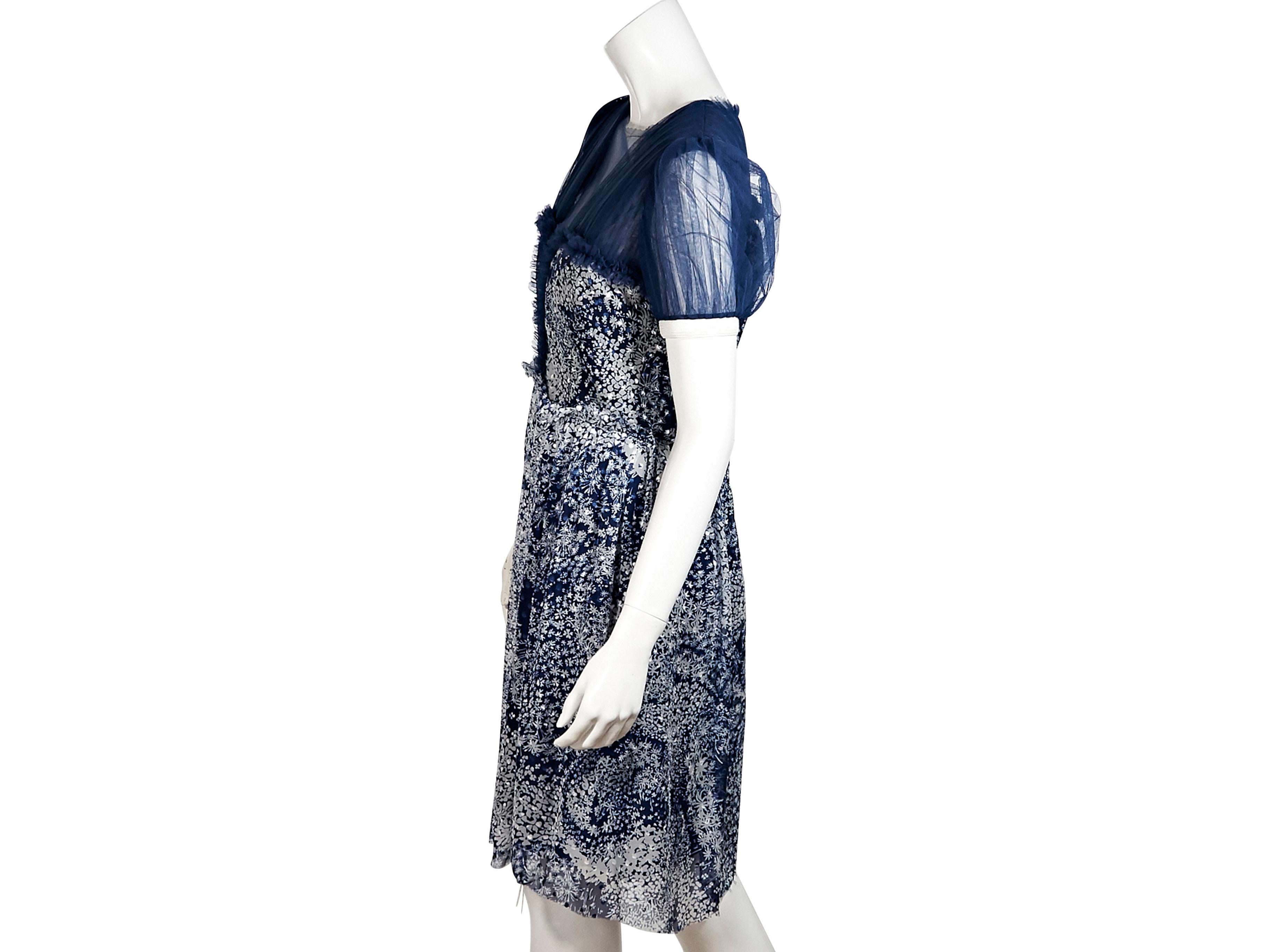 Product details:  Blue and white printed silk-blend dress by Rodarte.  Roundneck.  Short sleeves.  Faux v-neck bodice.  Concealed back zip closure.  Pleated skirting.  37