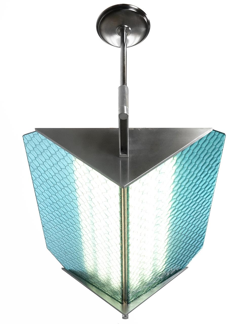 This is a clean high style modern lamp. The lines are very clean and simple using brushed aluminum. What makes it a bit edgy is the generous use of antique sky blue wire glass. We can change the down rods to suit your drop length. We only have one