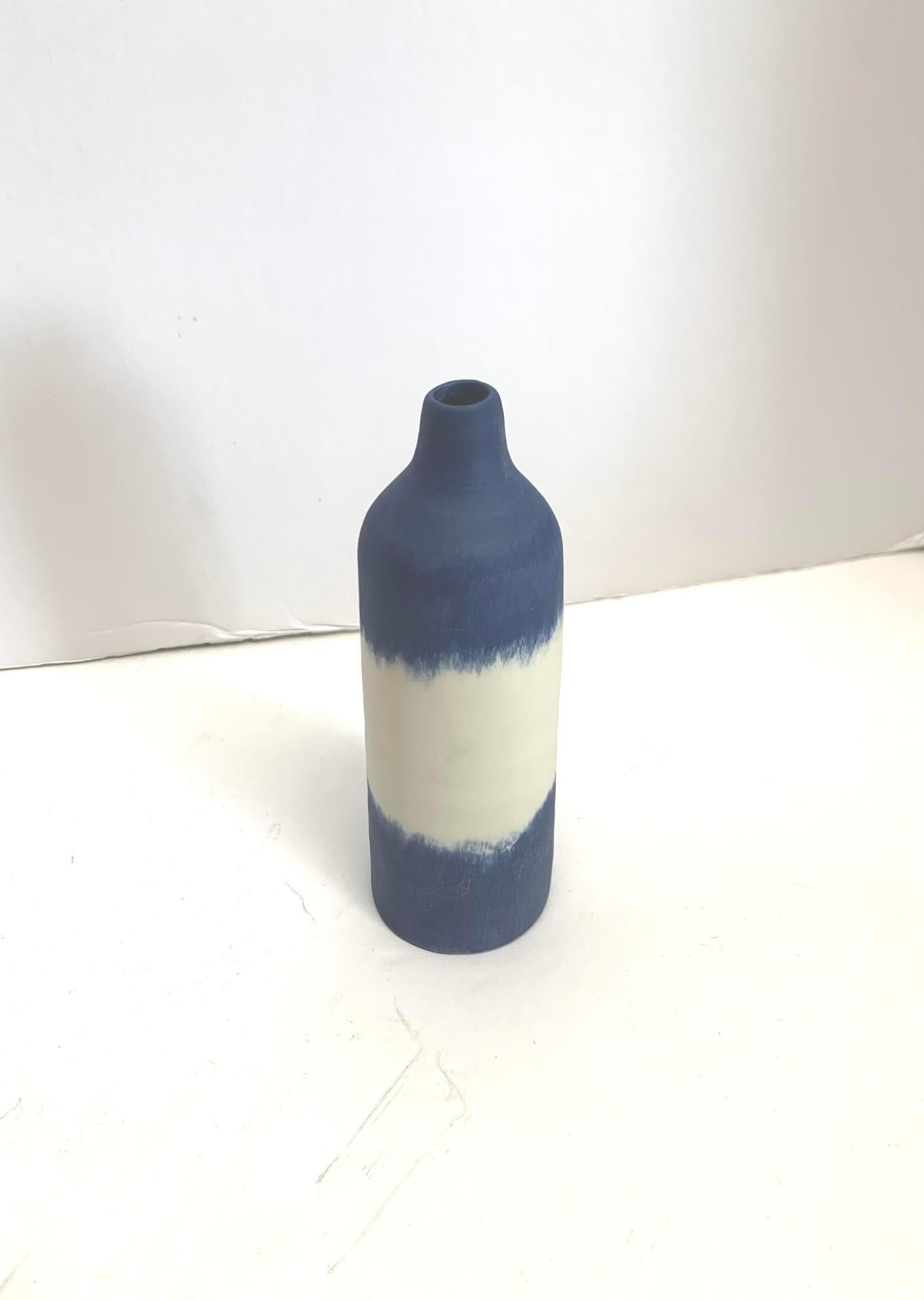 Contemporary Italian hand made ceramic blue with white band design thin vase.
Matte glaze.
Part of a large collection of blue and white diminutive vases.
See image #5.