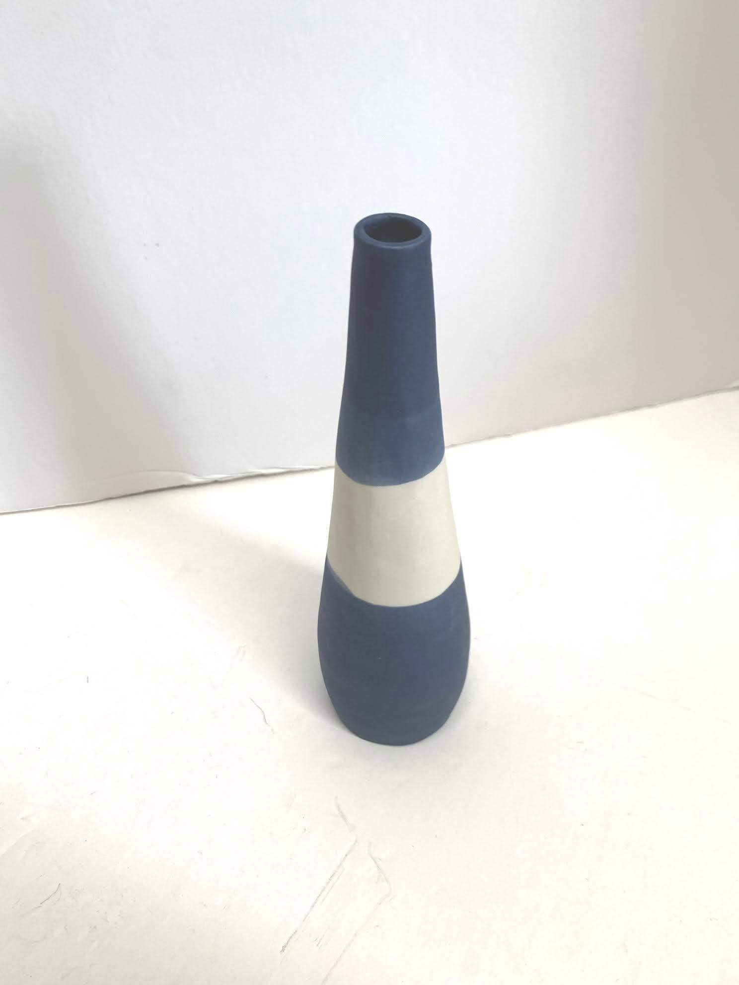 Contemporary Italian hand made ceramic blue ground thin vase with white color block design.
Matte glaze.
