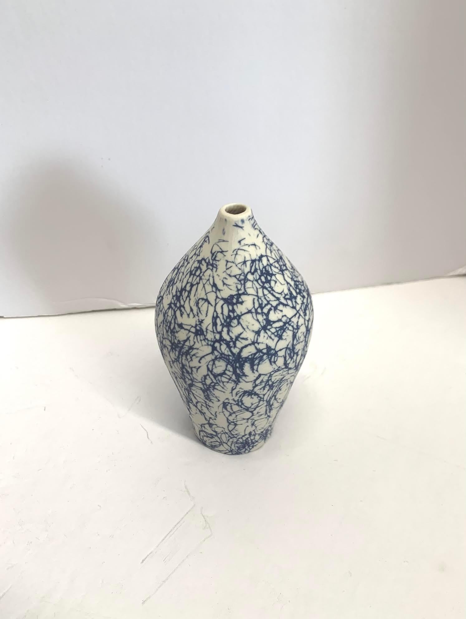 Contemporary Italian hand made ceramic blue vase with white confetti design.
Matte glaze.
Part of a large collection of blue and white diminutive vases.
See image #4.
