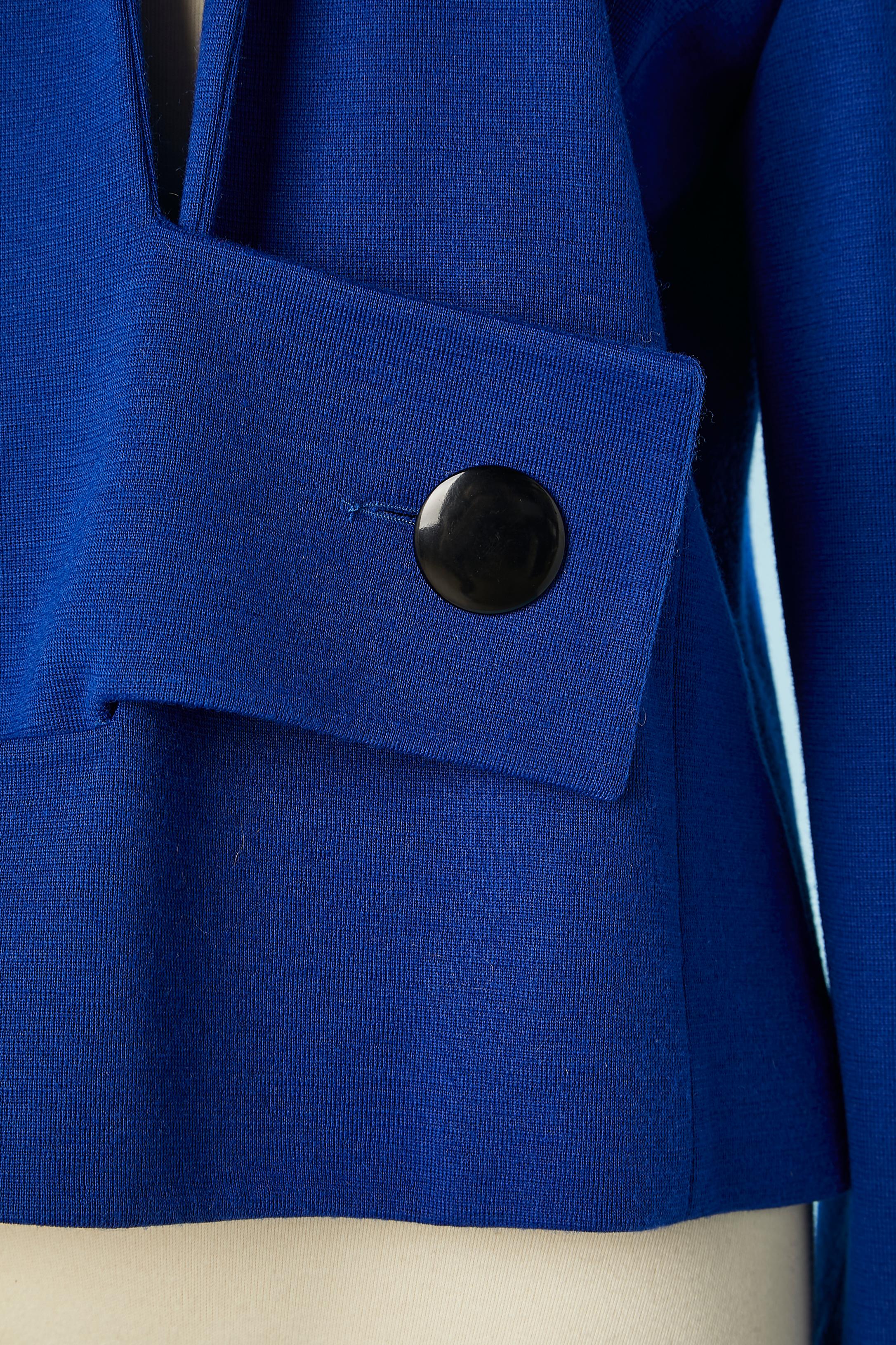 Blue wool jersey jacket with black buttons. Fabric composition: 50% wool, 50% acrylic. Silk lining. Shoulder pads. 
SIZE 42 (Fr) 12 (Us) 
