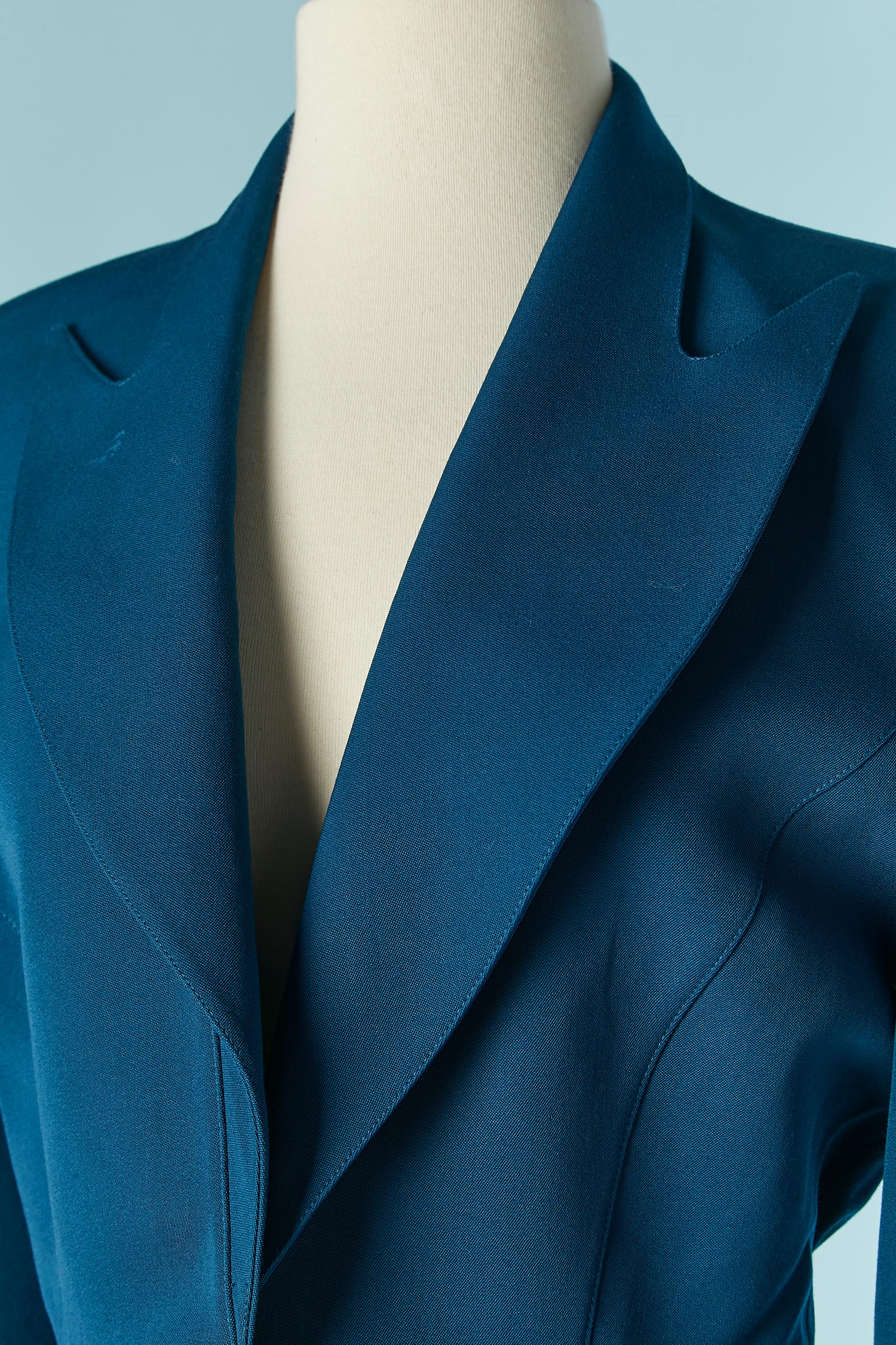 Blue wool skirt suit . No fabric composition tag for the lining but probably acetate. Cut-work. Snap closure on the middle front. 
Jacket size : 38/40 M/L 
Skirt size: 38 / M 