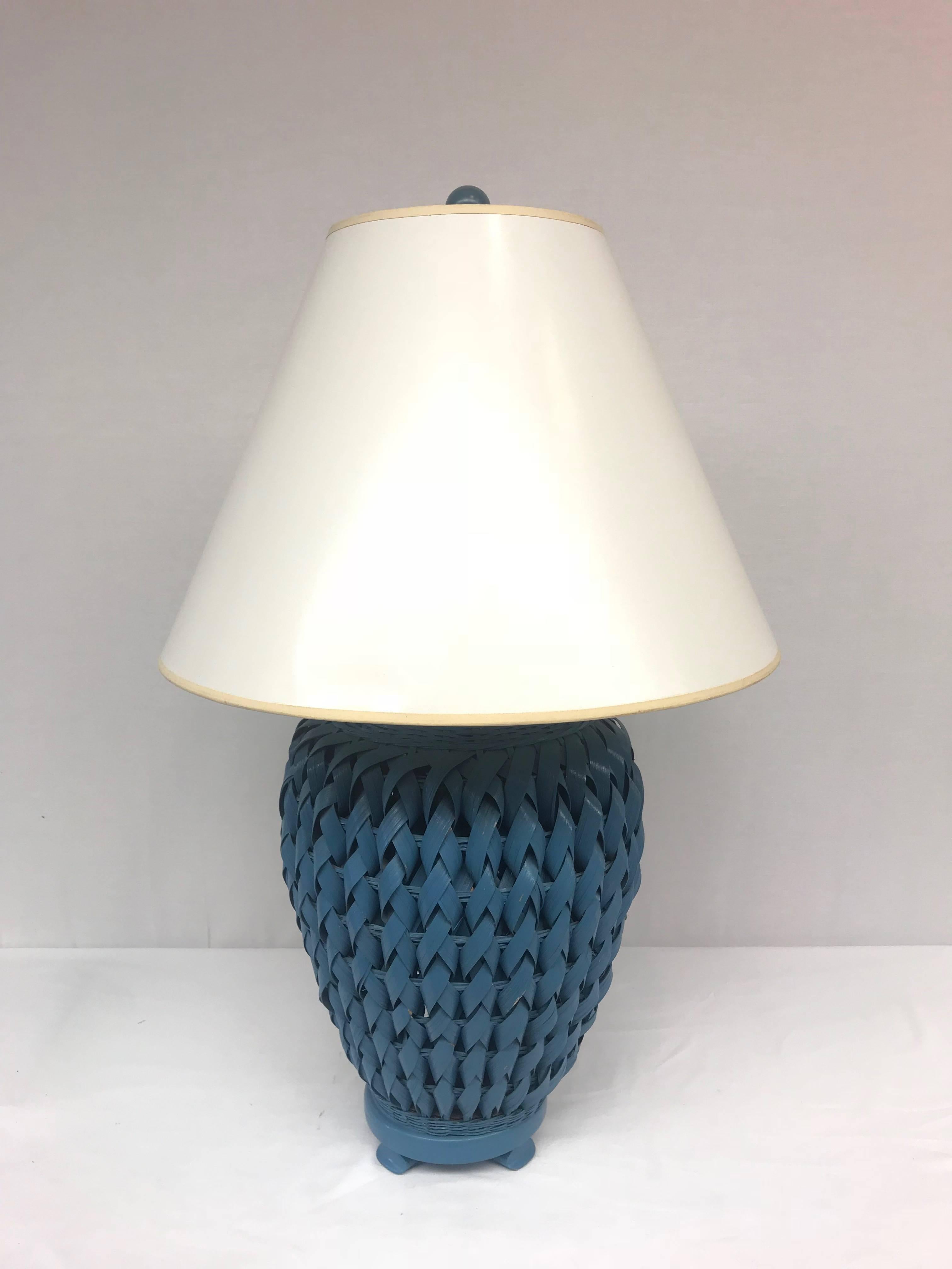 A unique blue-painted, woven wicker table lamp topped with a lacquered cream-colored paper shade. 60 watt bulb max. Lamp works and wiring is in good shape, but lamp has not been rewired.
Shade Dimensions: 9