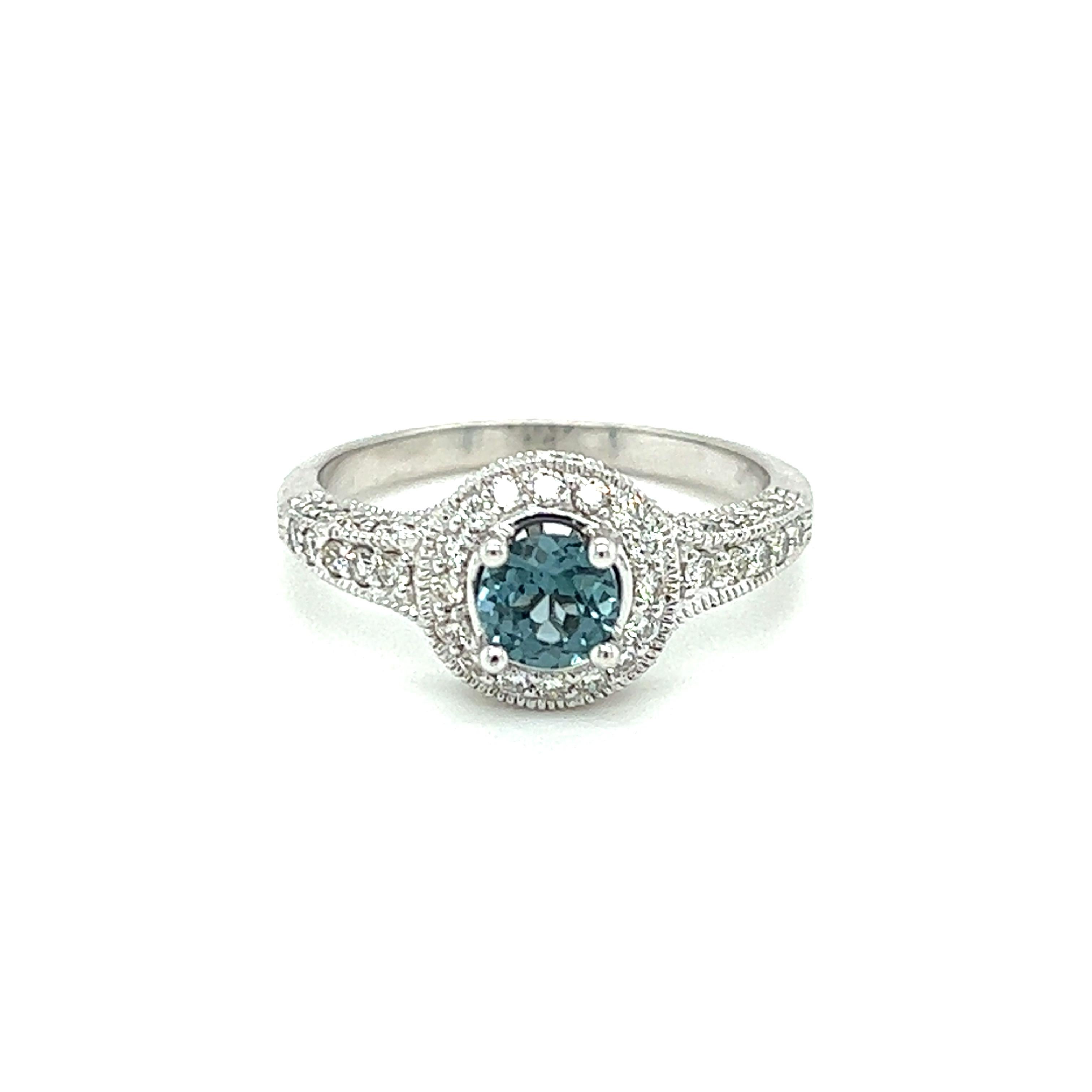 One 14-karat white gold ring set with one 0.72-carat round blue zircon and fifty-six (56) brilliant cut diamonds, approximately 0.52-carat total weight with matching H/I color and SI1 clarity. The ring is a finger size 7 and can be resized.  Sizing