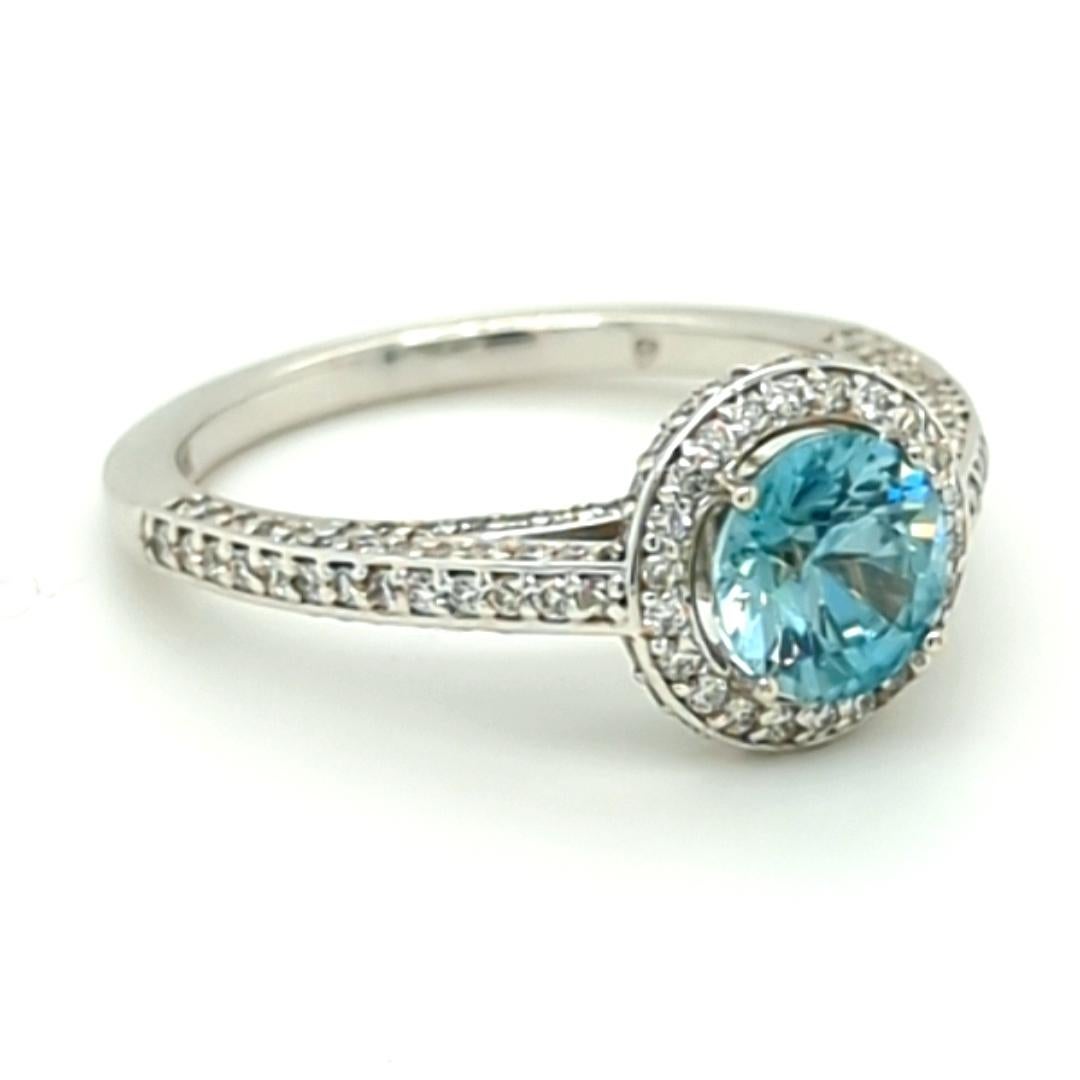 Sparkle, sparkle, sparkle! This Blue Zircon's radiance dances in the light as your hand moves, mimicking the sun dancing across the Gulf's soothing waters, accented with just a sprinkle of diamonds. This beautiful ring has 1/2 carat of diamond and a