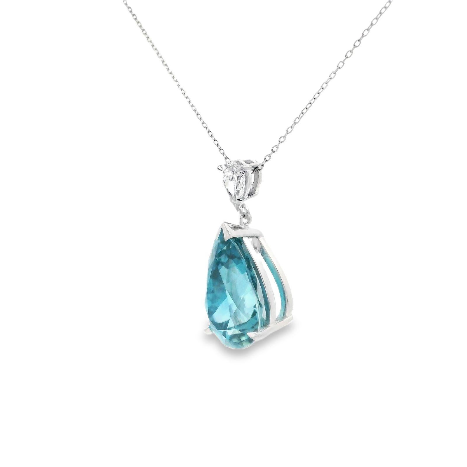 A blue zircon and diamond pendant together with a chain in 18 karat white gold.

This simple and elegant pendant is set with a pear cut blue zircon of 10.55 carats suspended from a matching pear brilliant cut diamond of 0.31 carats.

The blue zircon