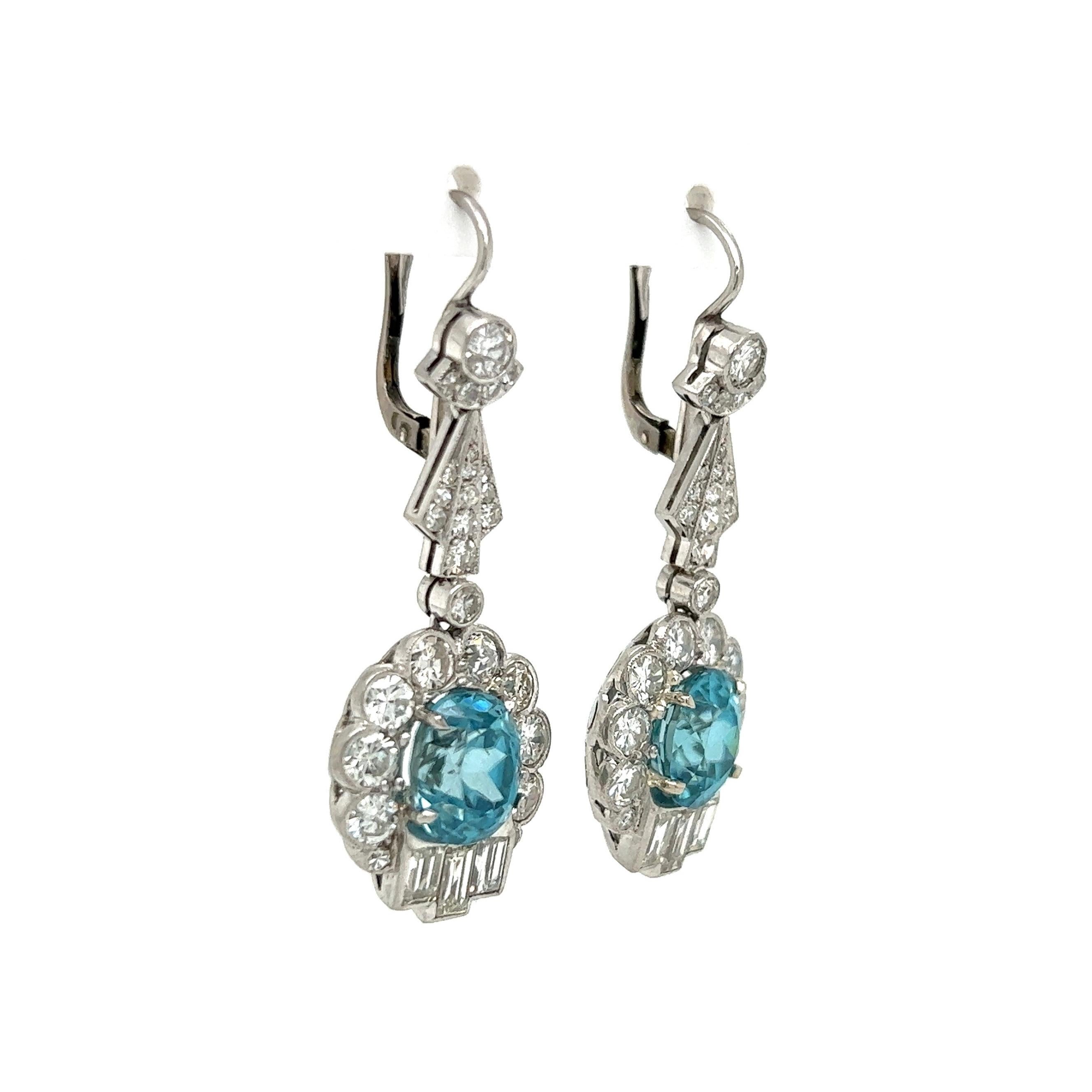 Simply Beautiful! Finely detailed Art Deco Blue Zircon and Diamond Platinum Drop Earrings. Each earring Hand set with a Blue Zircon Gemstone. Approx. 8.40tcw for both. Artfully surrounded by Old European cut Diamonds, approx. 4.10tcw. Post and
