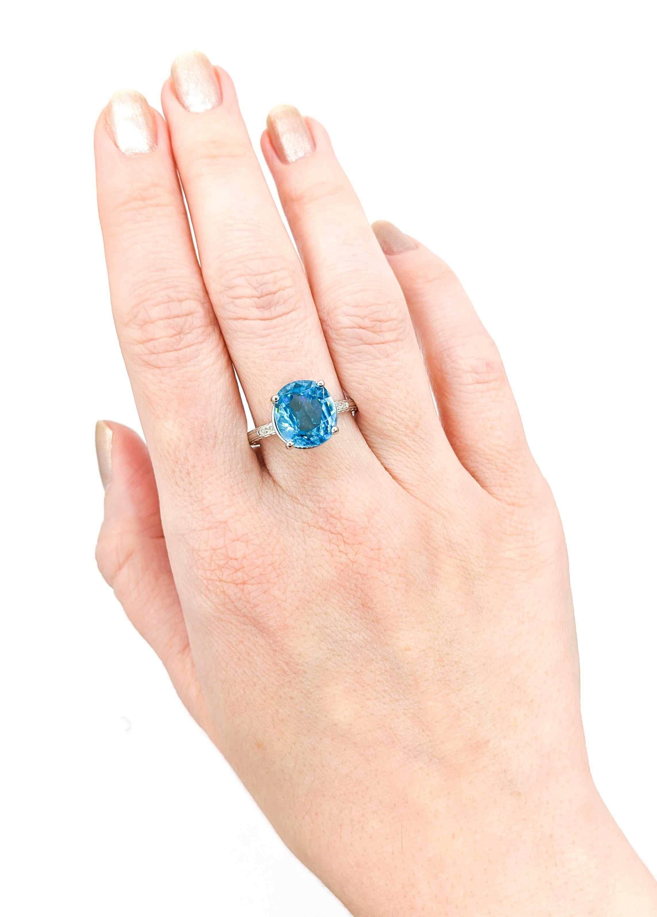 6.3 Carat Blue Zircon & Diamond Ring in White Gold

Expertly crafted in 18 karat white gold, this ring boasts a stunning 6.3ct blue zircon as its centerpiece. The blue zircon is a beautiful medium blue, adding richness to the ring. Currently in size