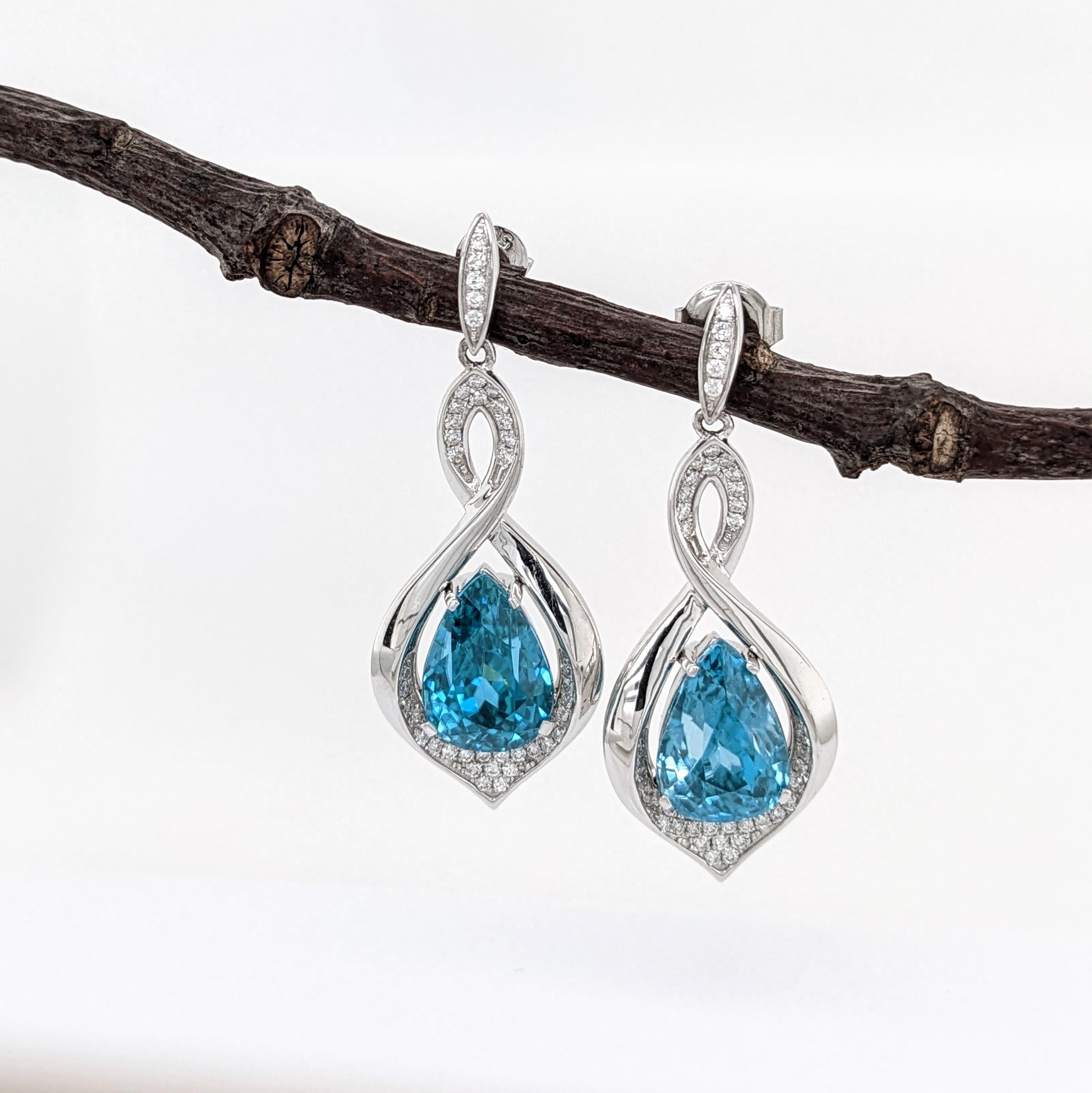 These beautiful earrings feature a pair of 13.31 carat weight pear shape Blue Zircon gemstones with natural earth mined diamonds set in solid 14K gold. These Blue Zircon earrings make a lovely December birthstone gift for your loved ones!