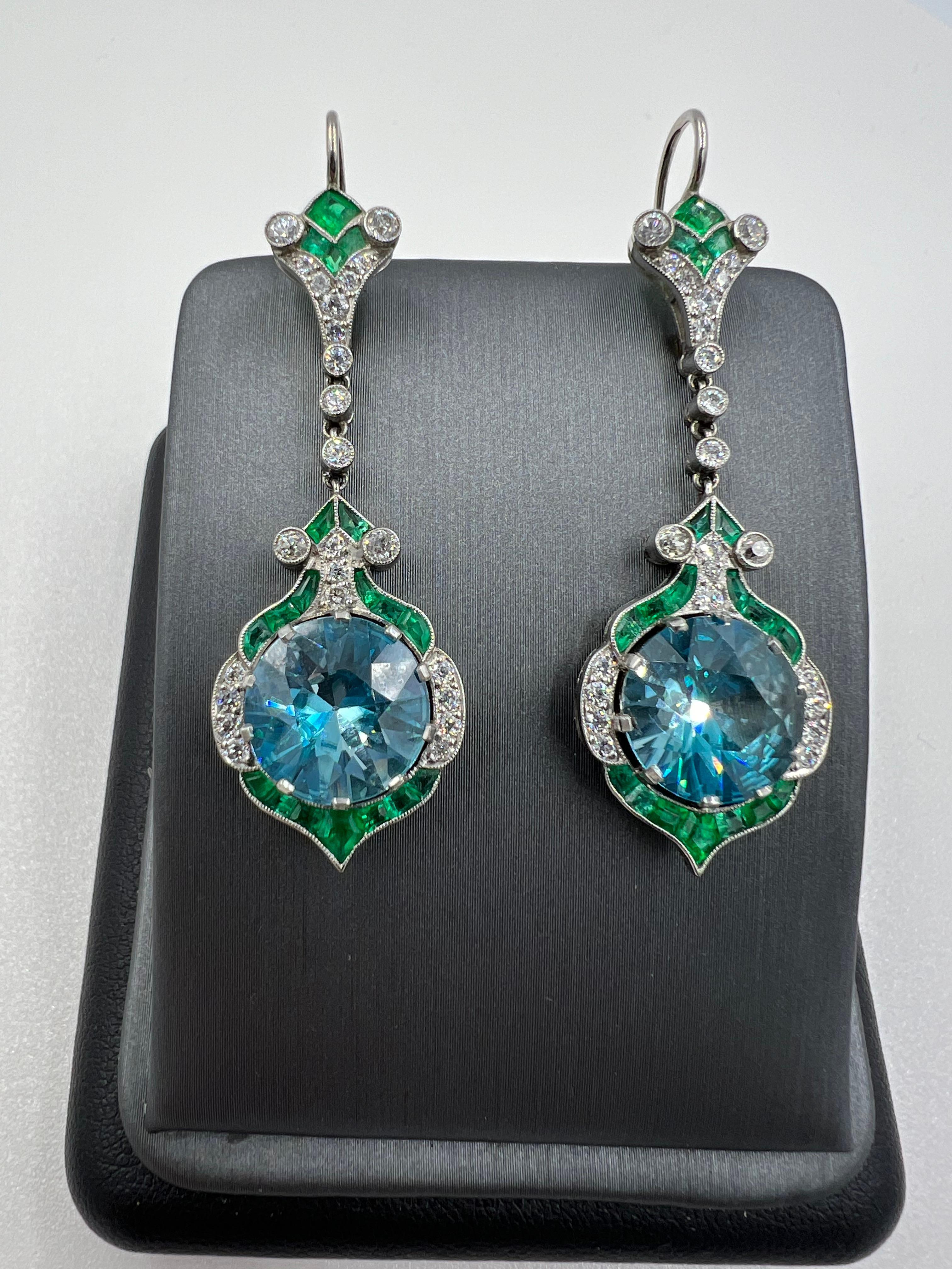 Blue Zircon Emerald Diamond platinum dangling earrings.

   Elegance and sophistication are epitomized in the exquisite Blue Zircon Emerald Diamond Platinum Dangling Earrings. Crafted with precision and attention to detail, these stunning earrings