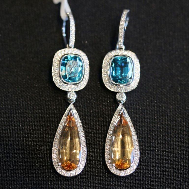 These exceptionally beautiful Empress earrings earned their name due to the Imperial Topaz we use in the design. These earrings are hand-crafted in our workshop from 18ct White Gold, 11.05ct Blue Zircon, 10.57ct Imperial Topaz surrounded by 1.23ct