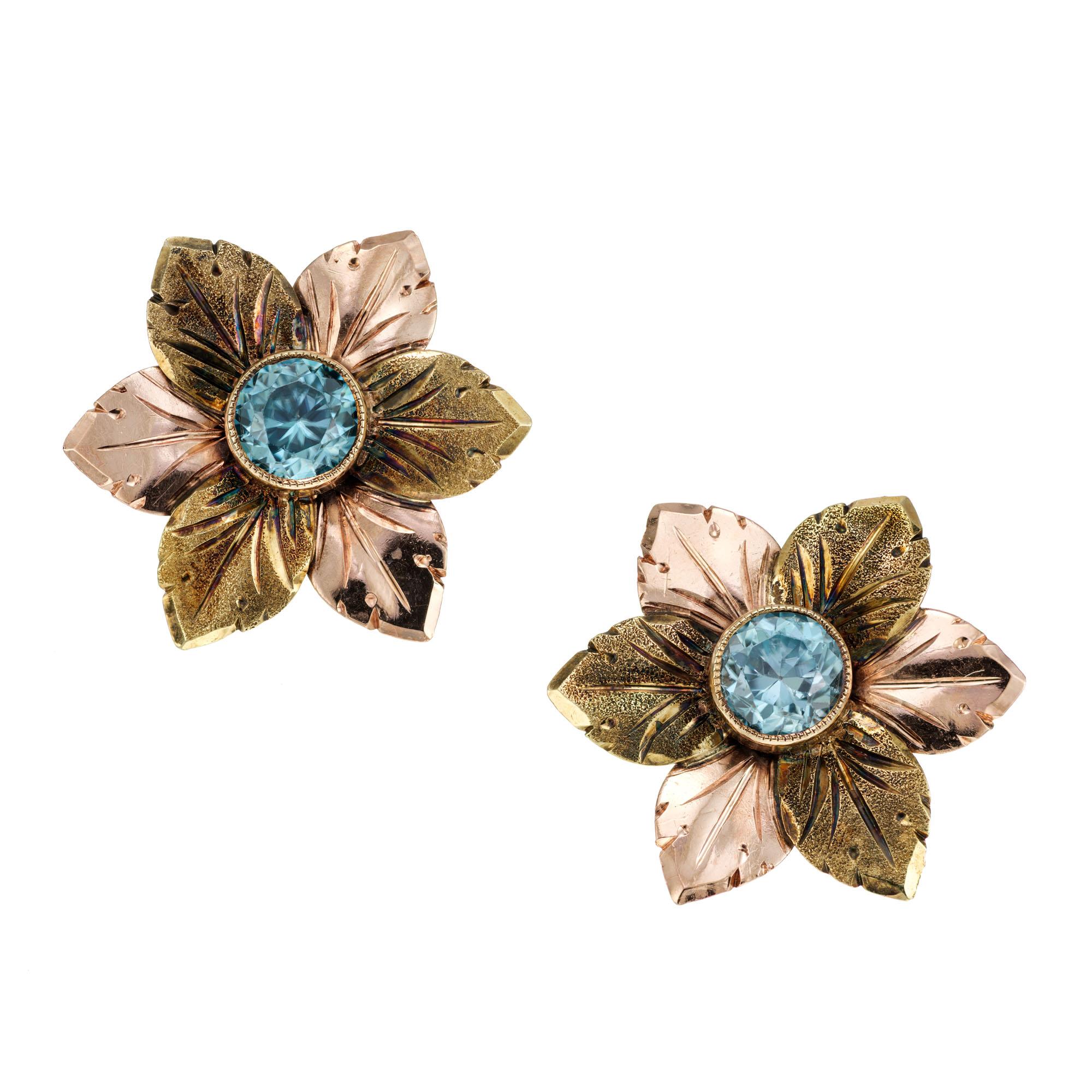 Handmade rose and green gold hand engraved flower earring and brooch set with genuine untreated bright blue round Zircons. Circa 1935.

4 round Blue Zircon approx. total weight 2.40cts
Stamped: 14k P & G
16.1 grams
Diameter of brooch: 1.62