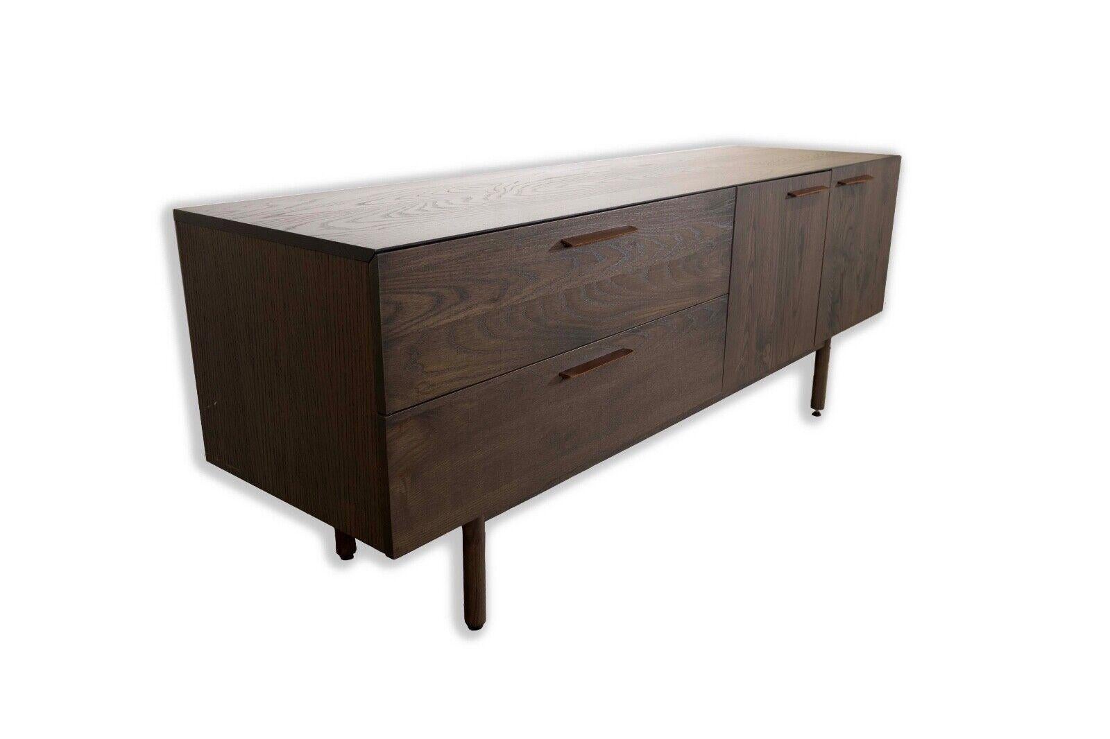 The Blu Dot Shale 2 Drawer 2 Door Console Credenza Sideboard seamlessly blends contemporary aesthetics with modern functionality. Crafted with precision, its sleek design features two spacious drawers and two doors, providing ample storage space for