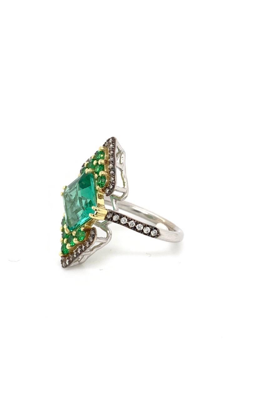 The 18 K White and Yellow Gold Ring “Green Empress” Featuring Exquisite BlueGreen Tourmaline Center,  Flanked by Tsavorite Garnets and Colorless Diamonds. One of a Kind, made in NYC.
BlueGreen Tourmaline 3.11 CT's Total Weight
10 Tsavorite Garnets
